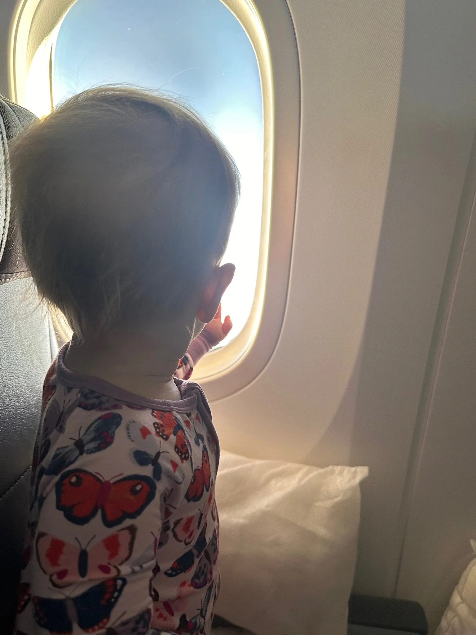 Getting a seat for our toddler was the best decision we made for a long-haul flight! Our airline allowed inflatable foot rests, so she had her own little bed!