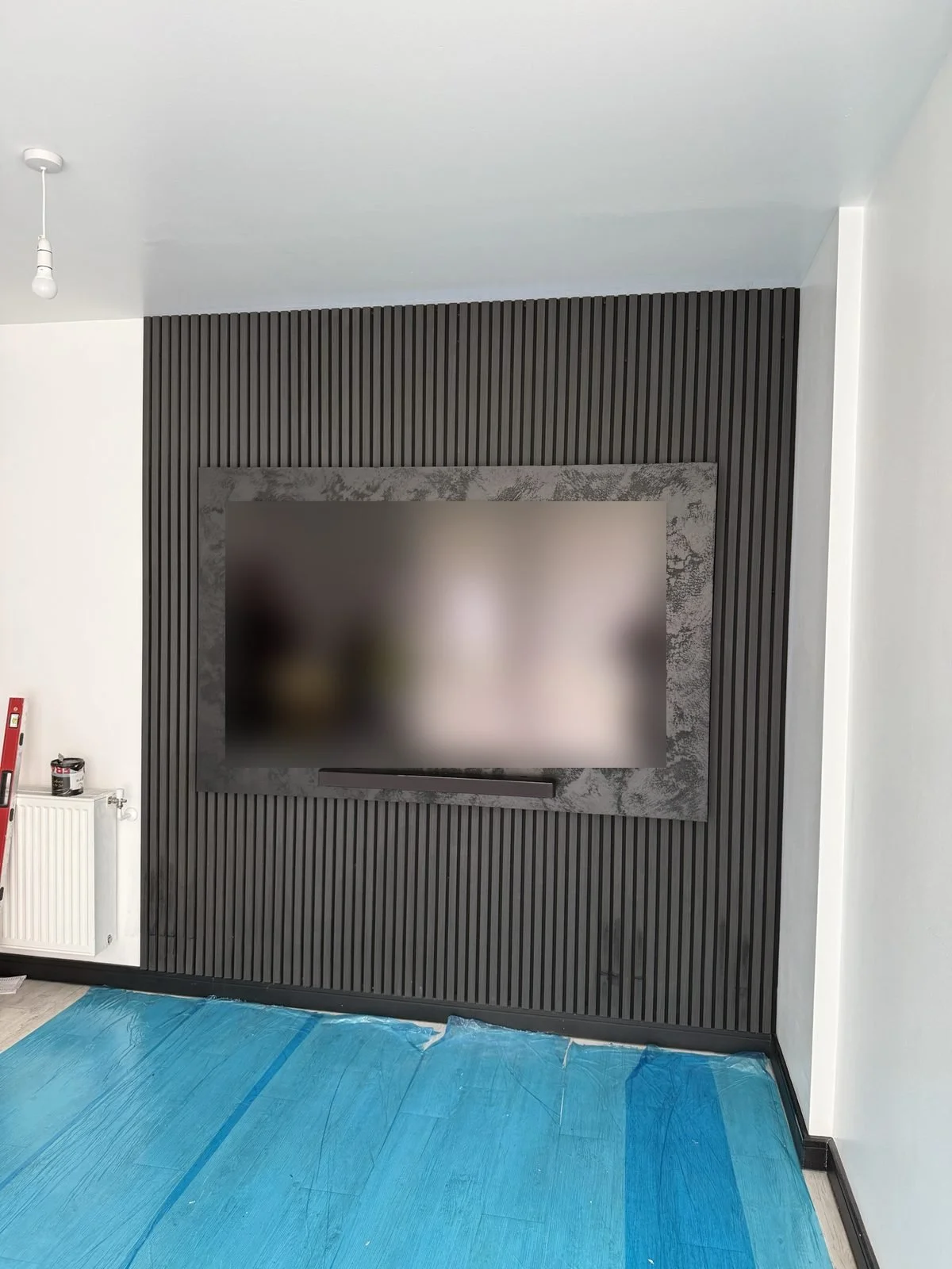 Grey slat panel media wall with a stone-effect TV surround