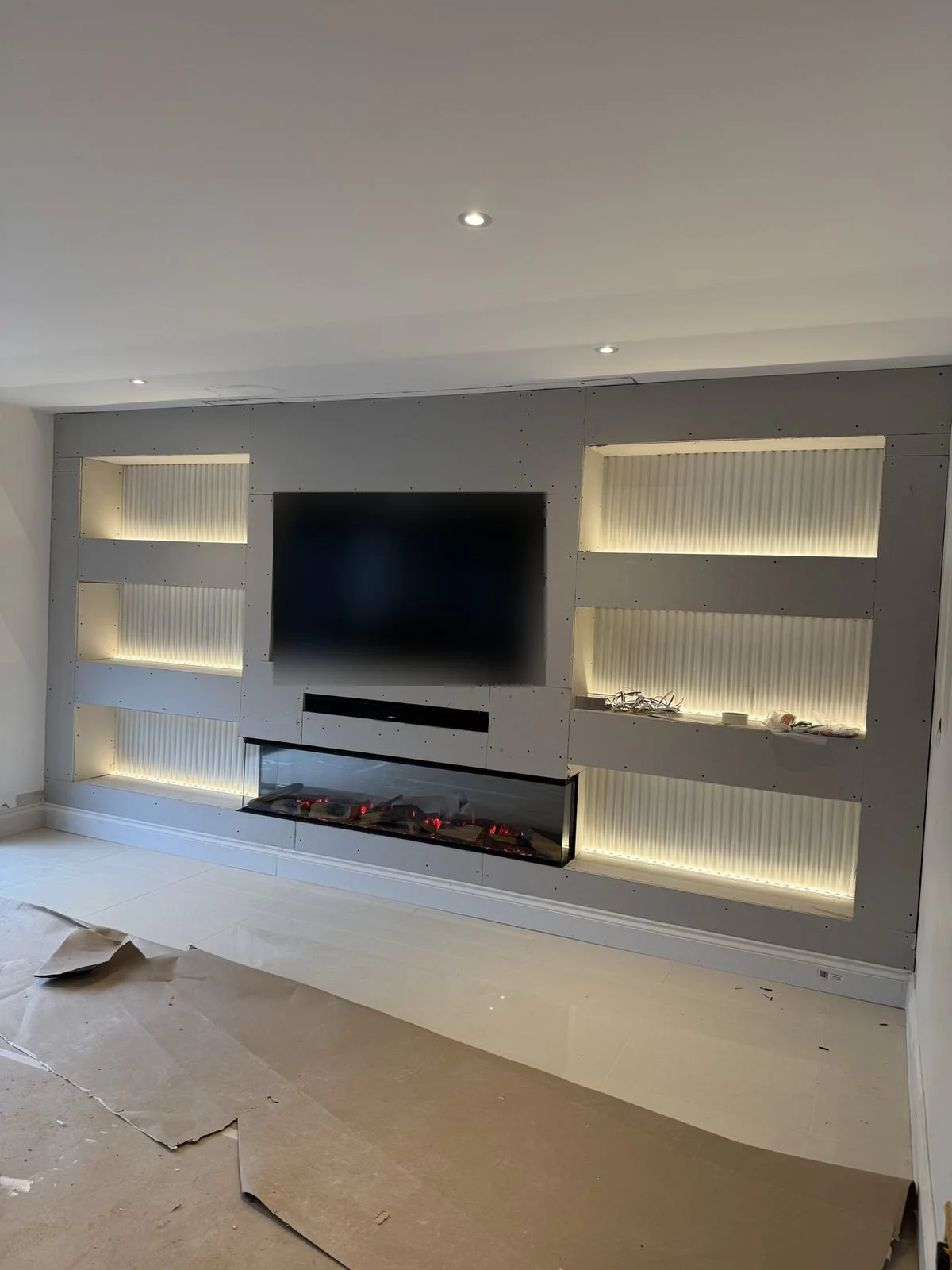 Build-stage media wall with recessed TV and fire opening