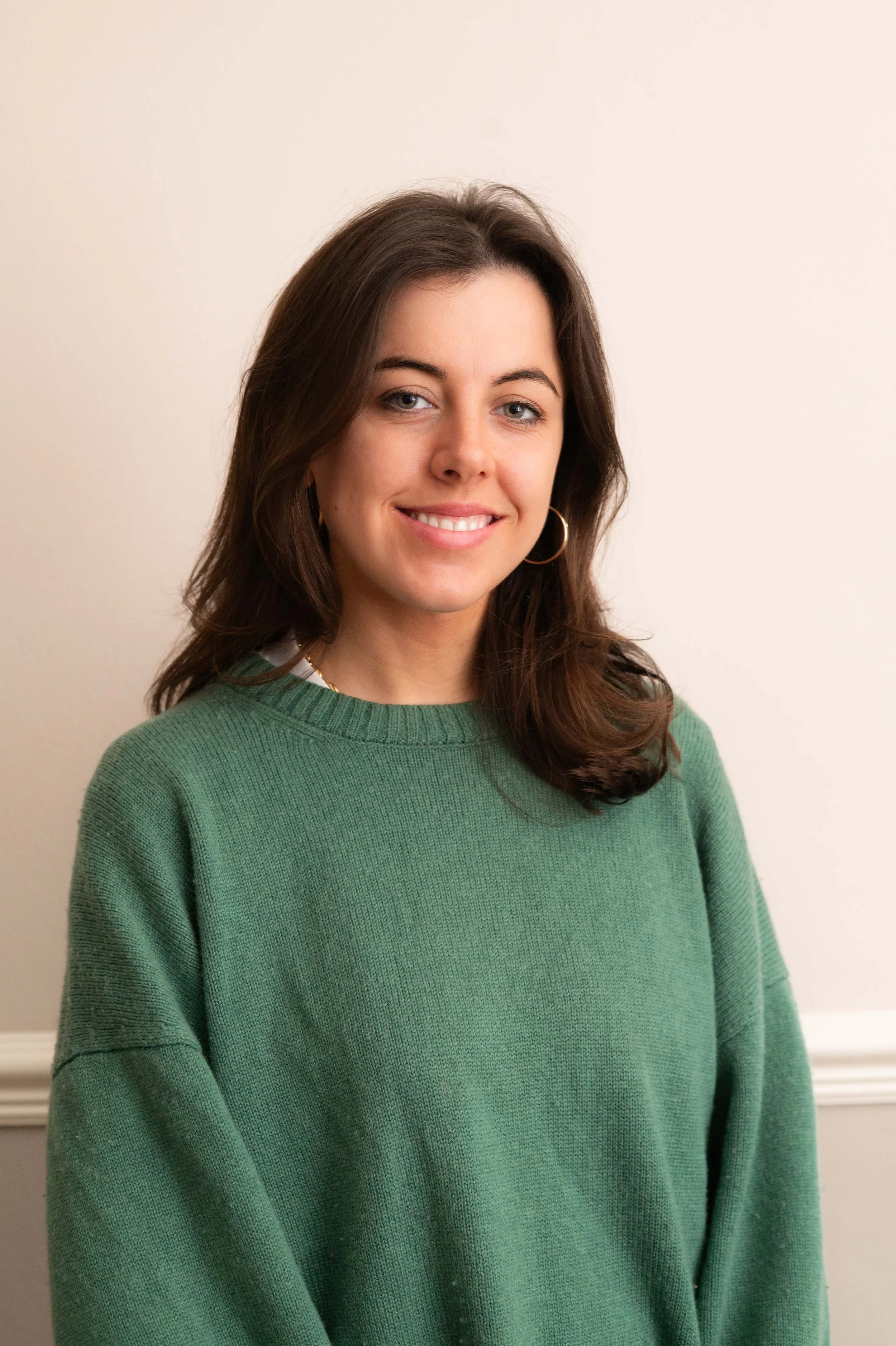 Tilda White trainee therapist at The Brixton Practice in London, wearing a green jumper