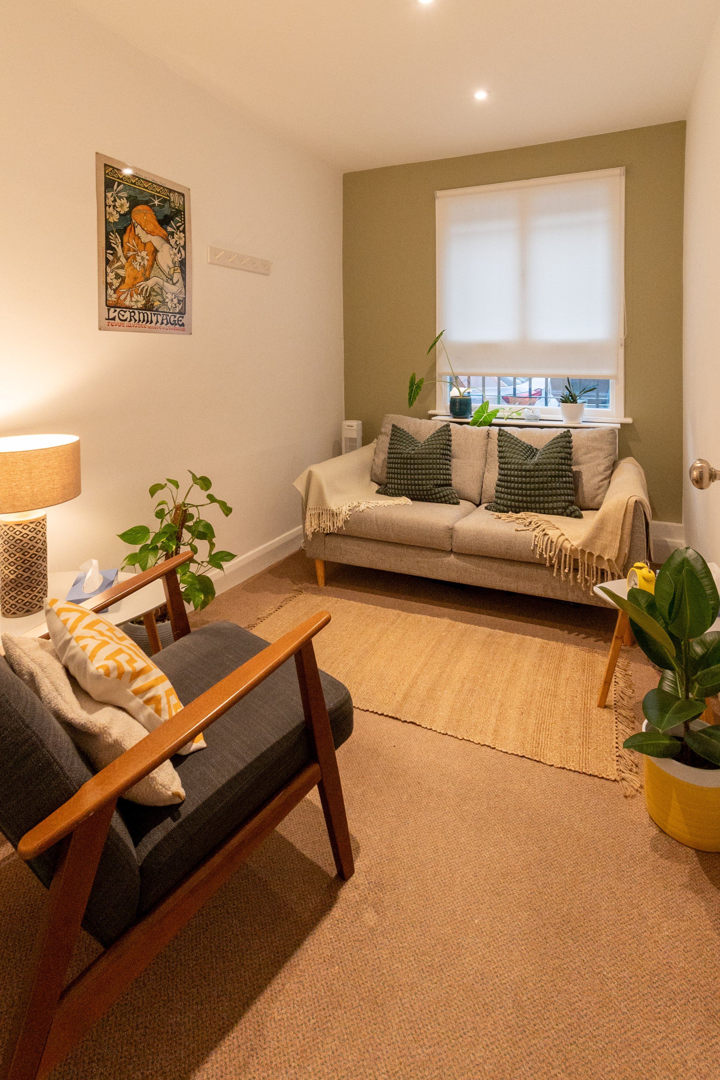 A cozy lit therapy room at The Brixton Practice in London for therapists to have clinical supervision with sofas.