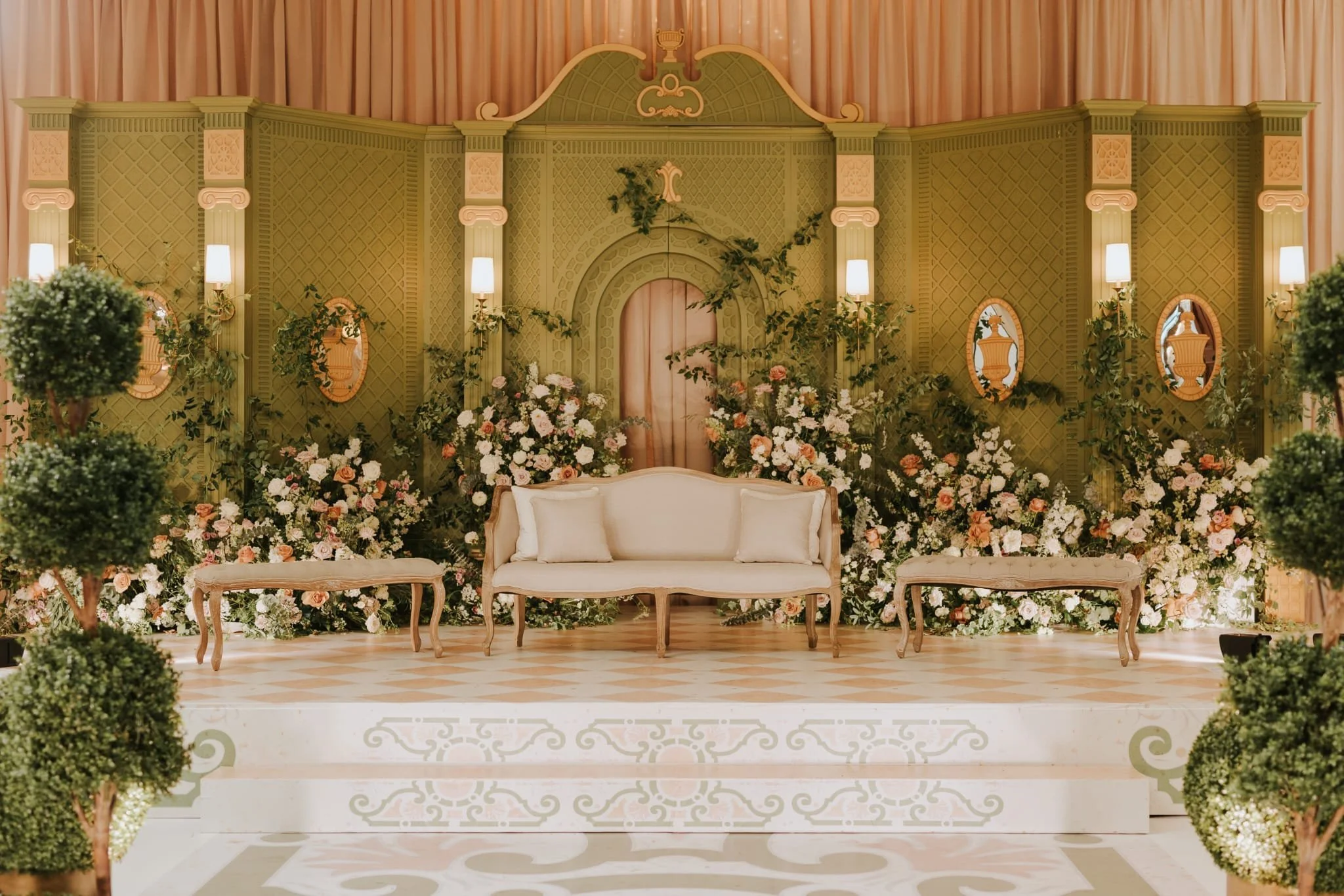 Grand green classical nikkah stage backdrop with garden florals and topiaries at the Royal Ambassador, by Ethereal Creators.