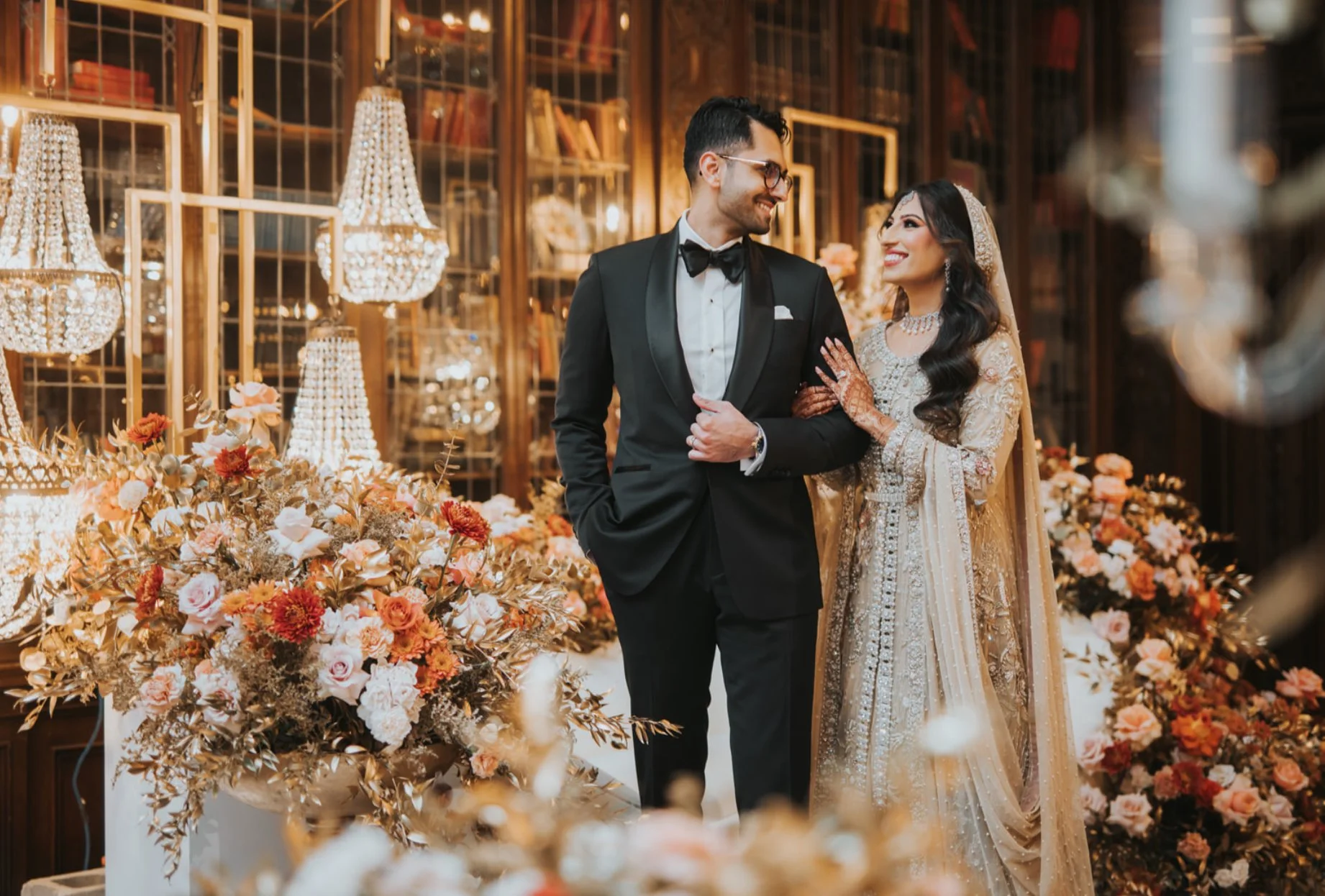 A real luxury wedding reception at the Casa Loma Library in Toronto, showcasing crystal lighting, bespoke floral decor, and refined event design.