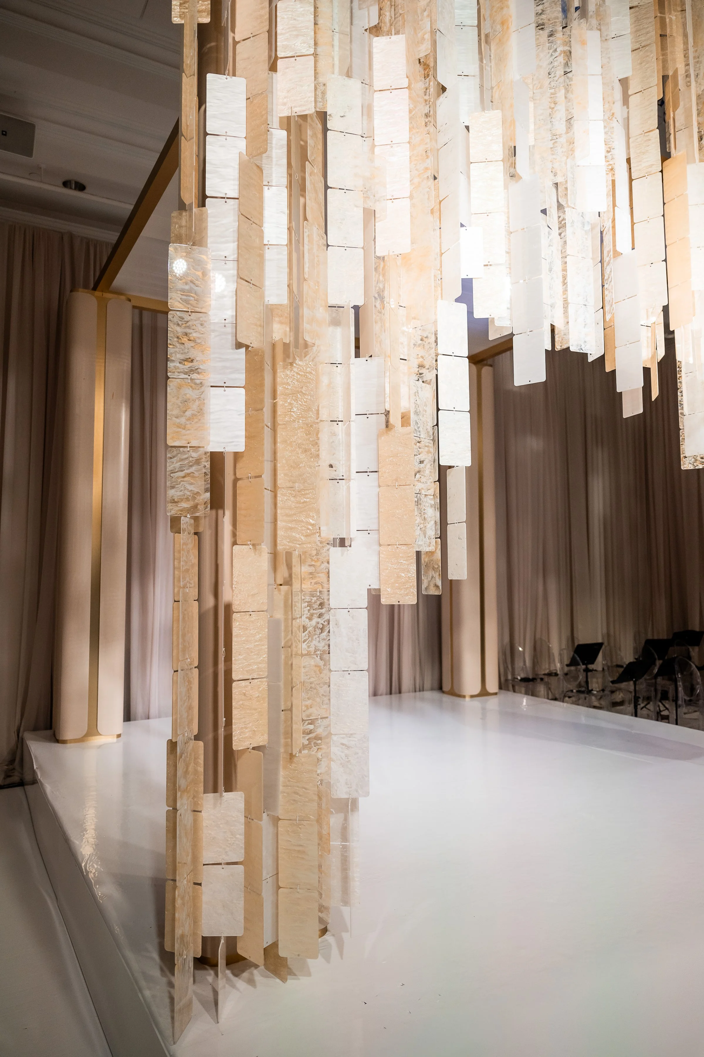 Close-up of layered iridescent acrylic panels forming a custom chuppah canopy by Ethereal Creators.
