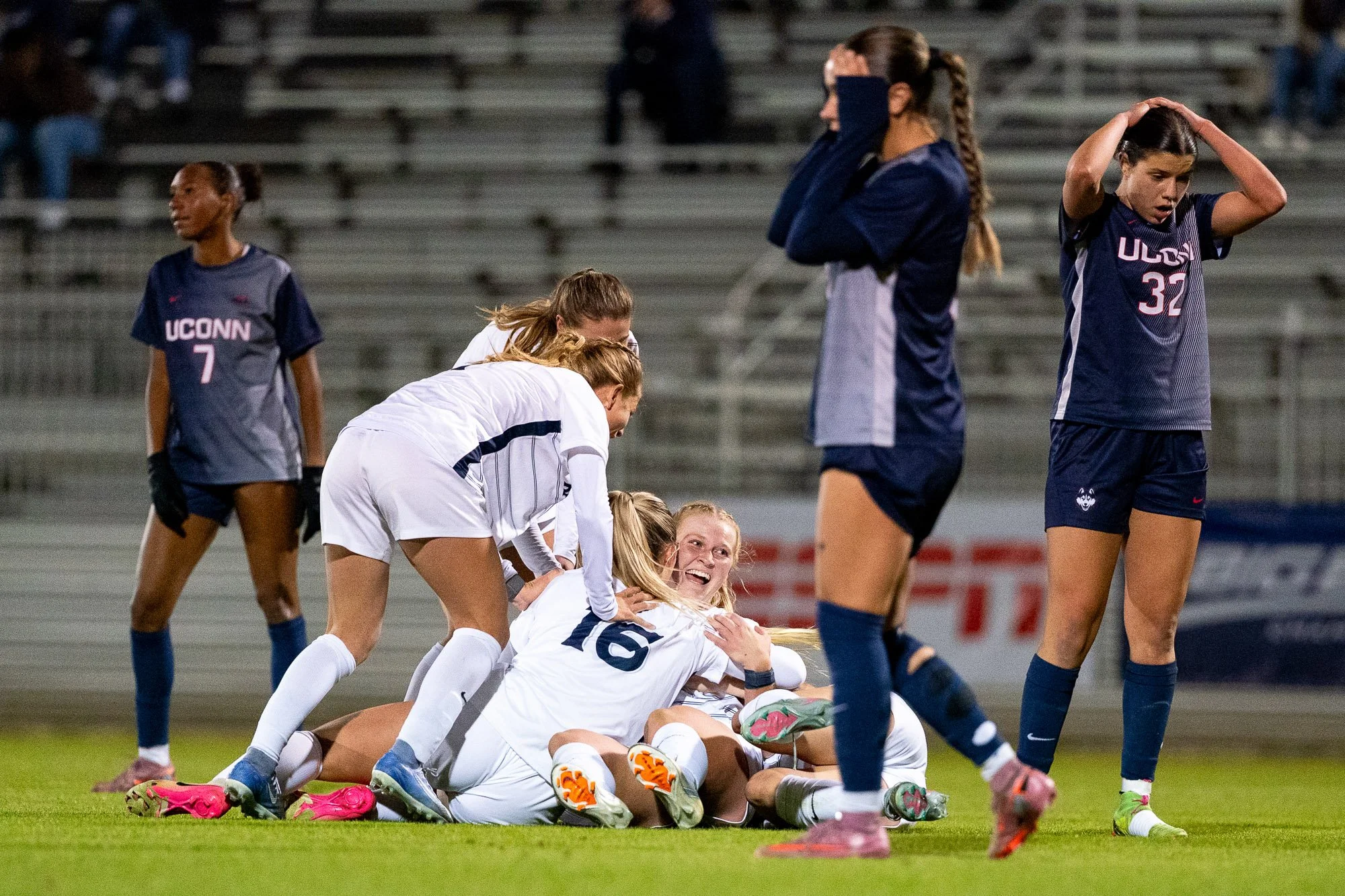 Xavier University players celebrate with Samantha Erbach after her goal against the University of Connecticut as UConn players react in the background during the BIG EAST Women’s Soccer Championship semifinal. Erbach recorded a hat trick in Xavier’s 