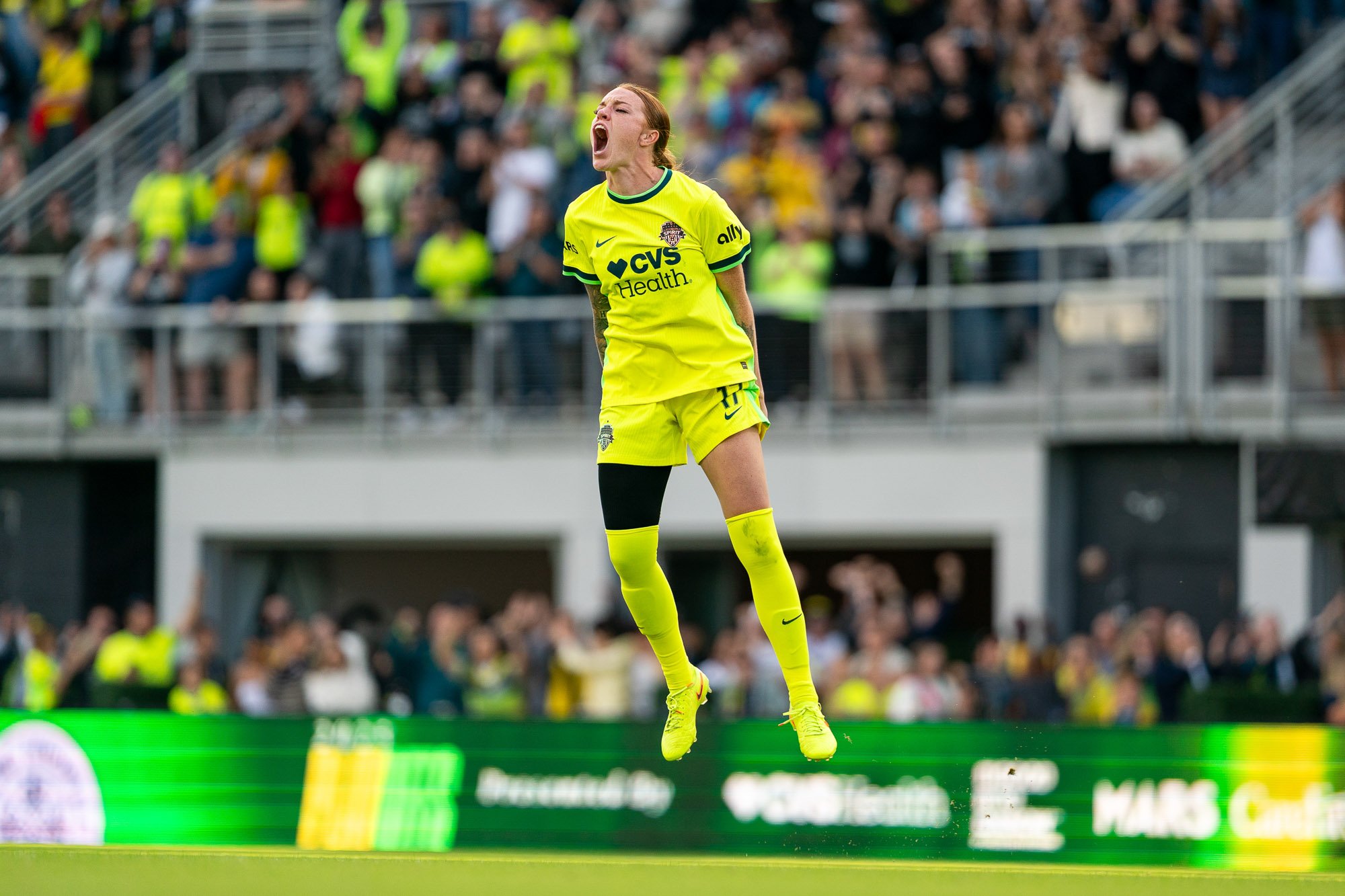 Washington Spirit midfielder Hal Hershfelt leaps into the air in celebration after converting her penalty kick during the NWSL Playoff Quarterfinal against Racing Louisville FC in 2025. (Cody Cervenka/Crvnka Photography)