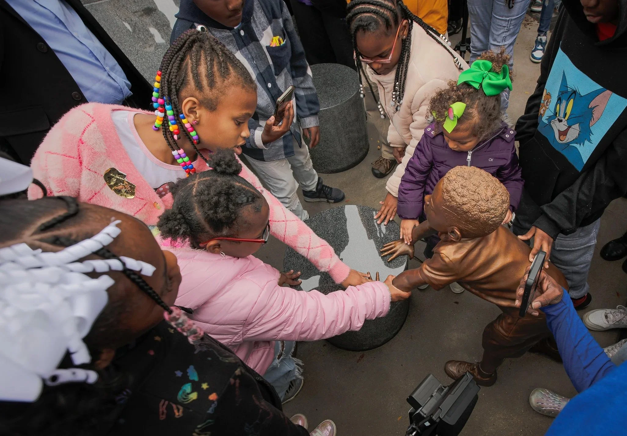 The children at the installation had never seen a black child depicted in bronze, and were delighted.