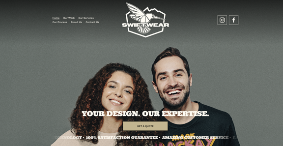 A smiling man and woman standing close together in front of a website homepage for Swift Wear, a clothing company, with a dark background and navigation links at the top.