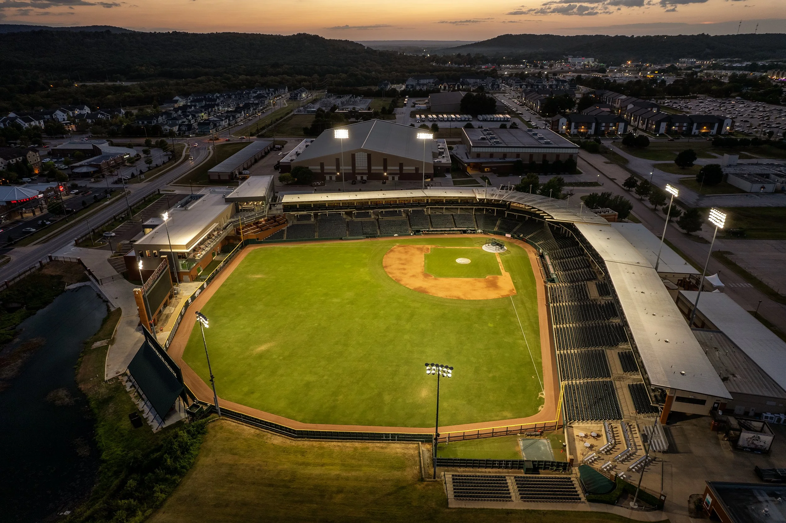 University-of-Arkansas-Baseball-Development-Center-Dusk-Aerial-Stadium-Wide.jpg