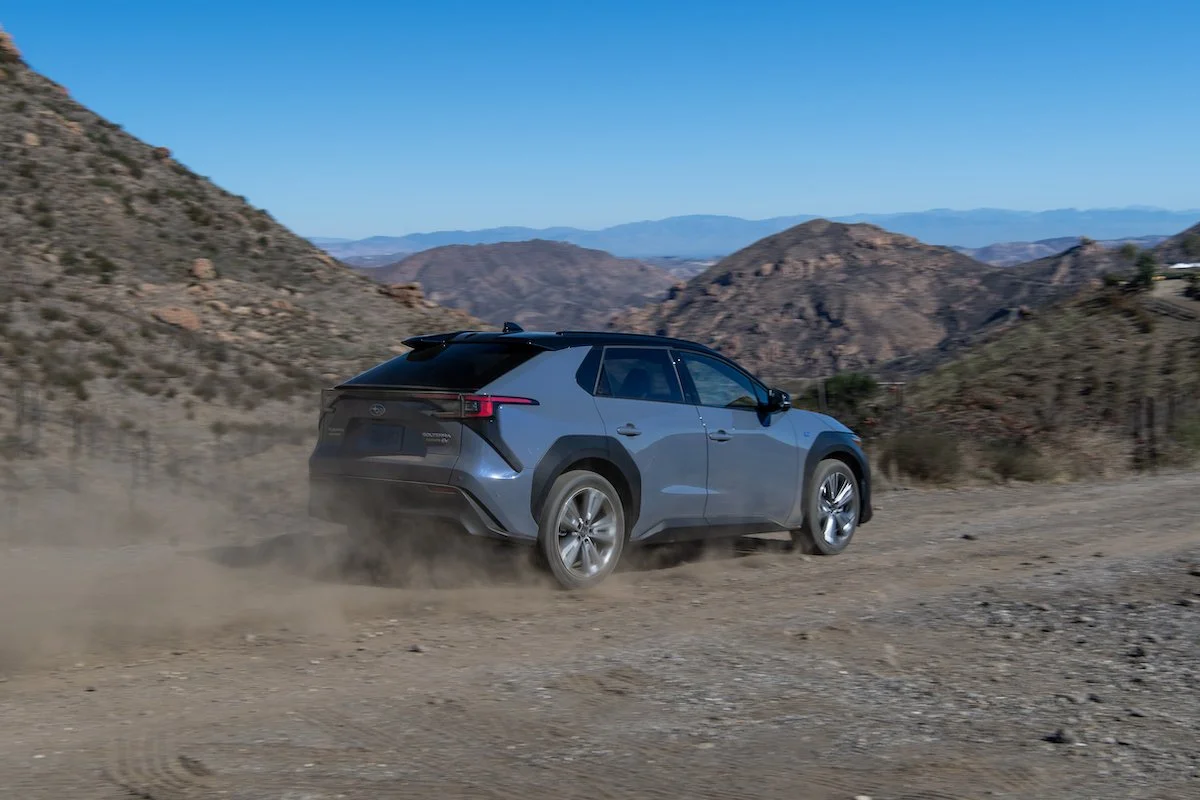 Subaru Solterra electric suv driving on a narrow dirt trail