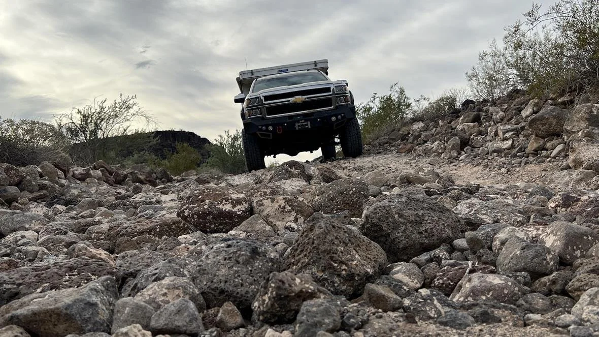Chevy truck with a Four Wheel Camper on the back