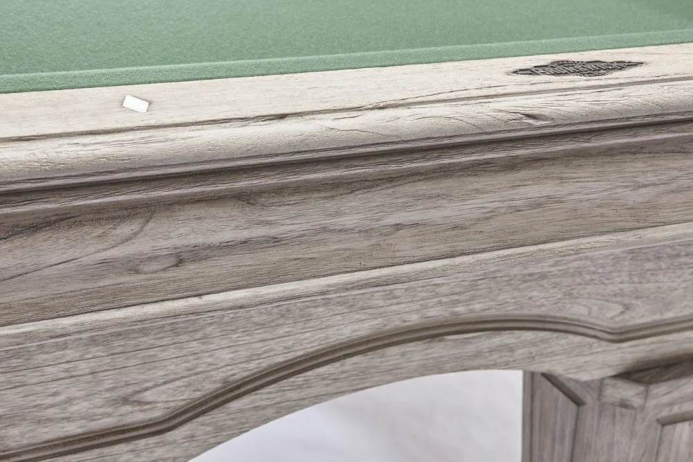 Close-up of a wooden furniture piece with a curved edge and a green ruler or measuring device on top