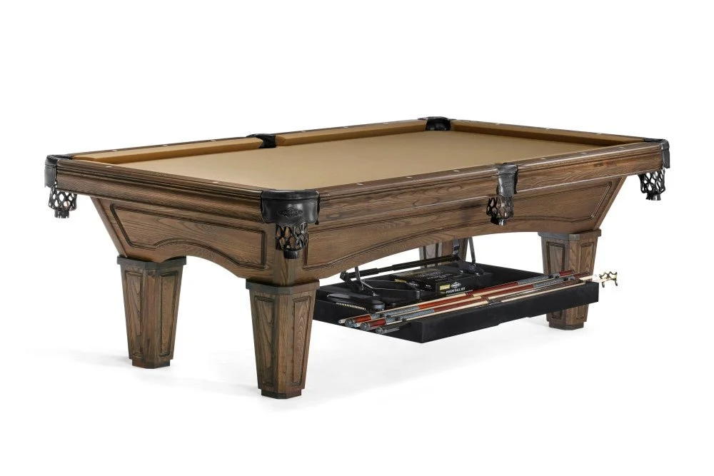 A traditional-style billiard table with wooden frame and beige felt surface, equipped with cues and a rack underneath.