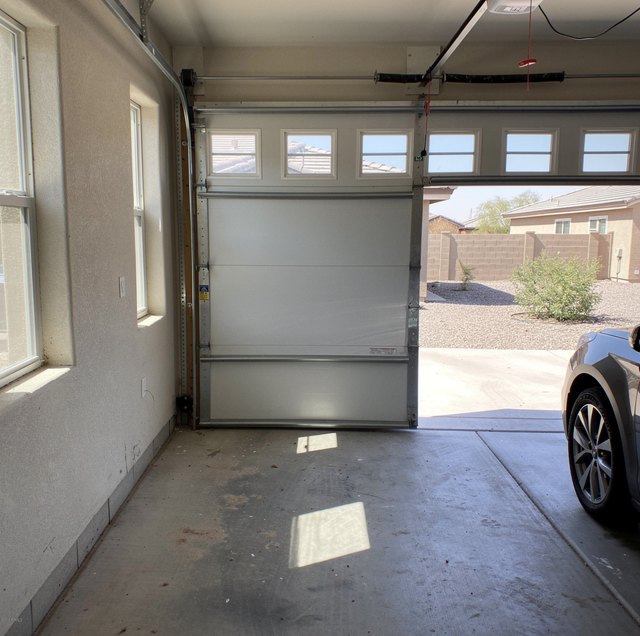 attached garage interior showing insulated and bare metal doors
