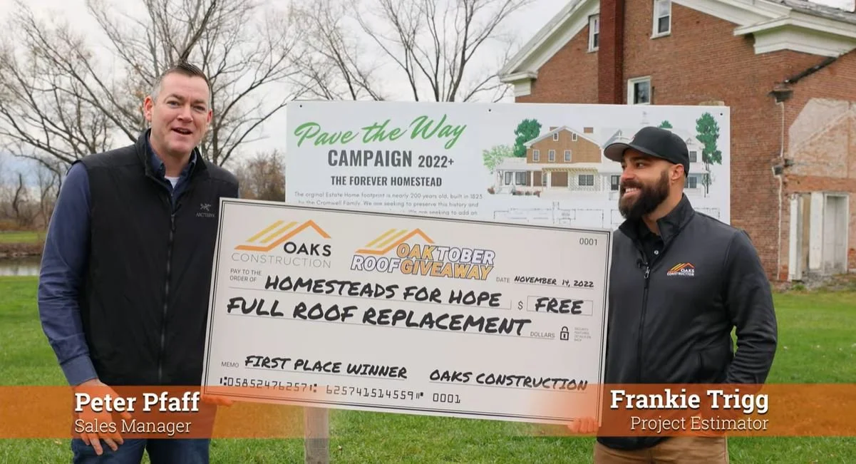 Two Oaks Construction Employees presenting a check donation for a new roof for the community center. 