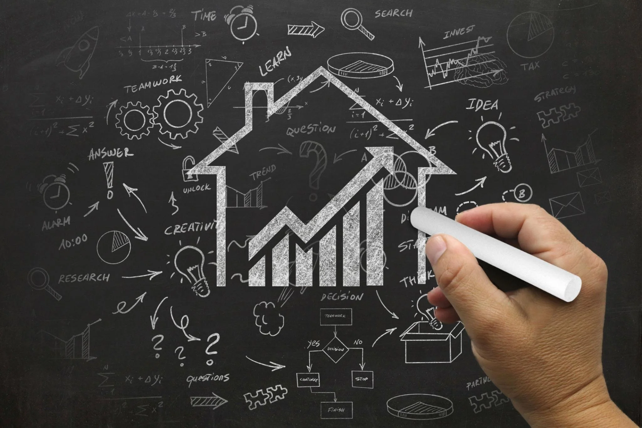 A person’s hands gently holding a small model house, representing the security and wealth-building potential of owning a home.