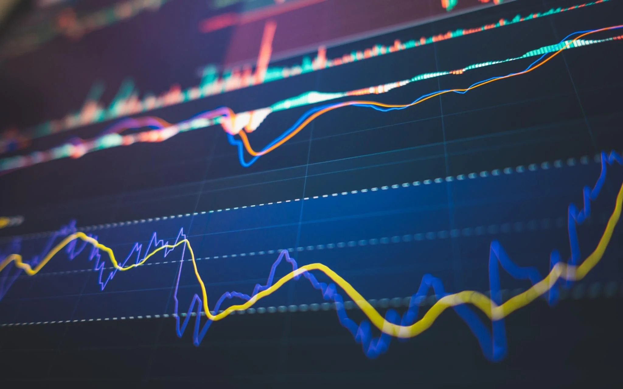 A close-up of a digital screen displaying colorful line graphs representing stock market or real estate interest rate trends.