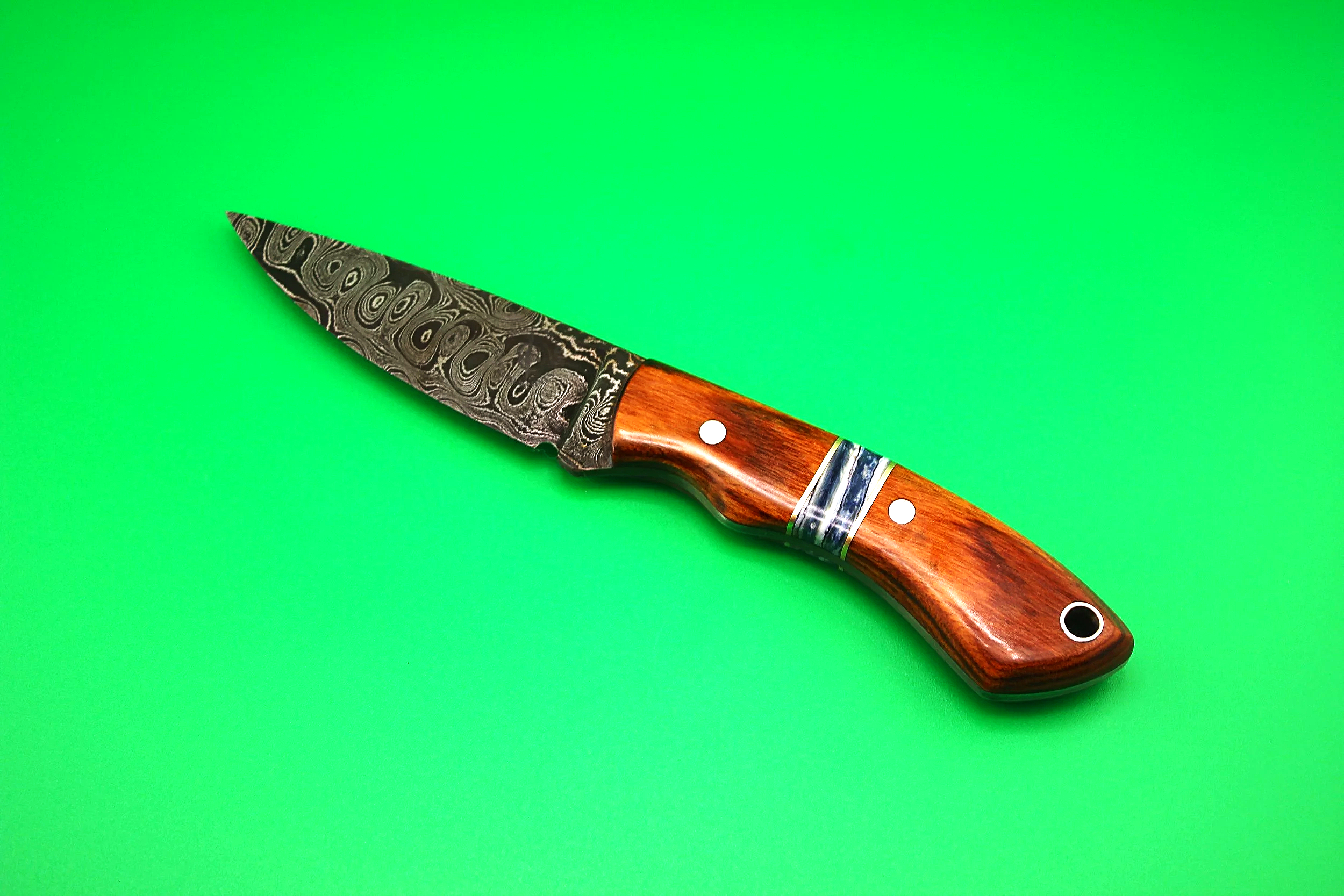 Damascus steel bird and trout knife, with custom copper, mammoth tooth, dessert ironwood segmented scales. 