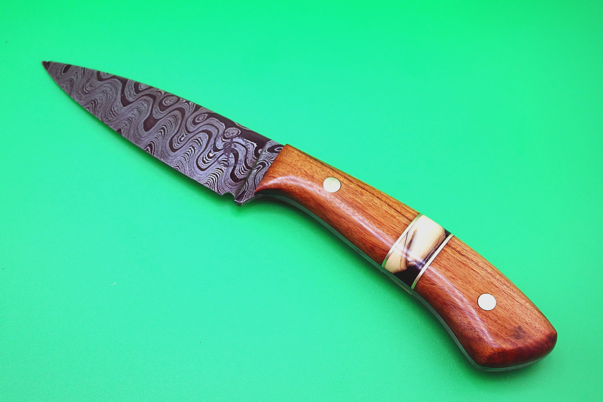 Damascus steel bird and trout knife with custom segmented copper, mammoth tooth and Ironwood scales.