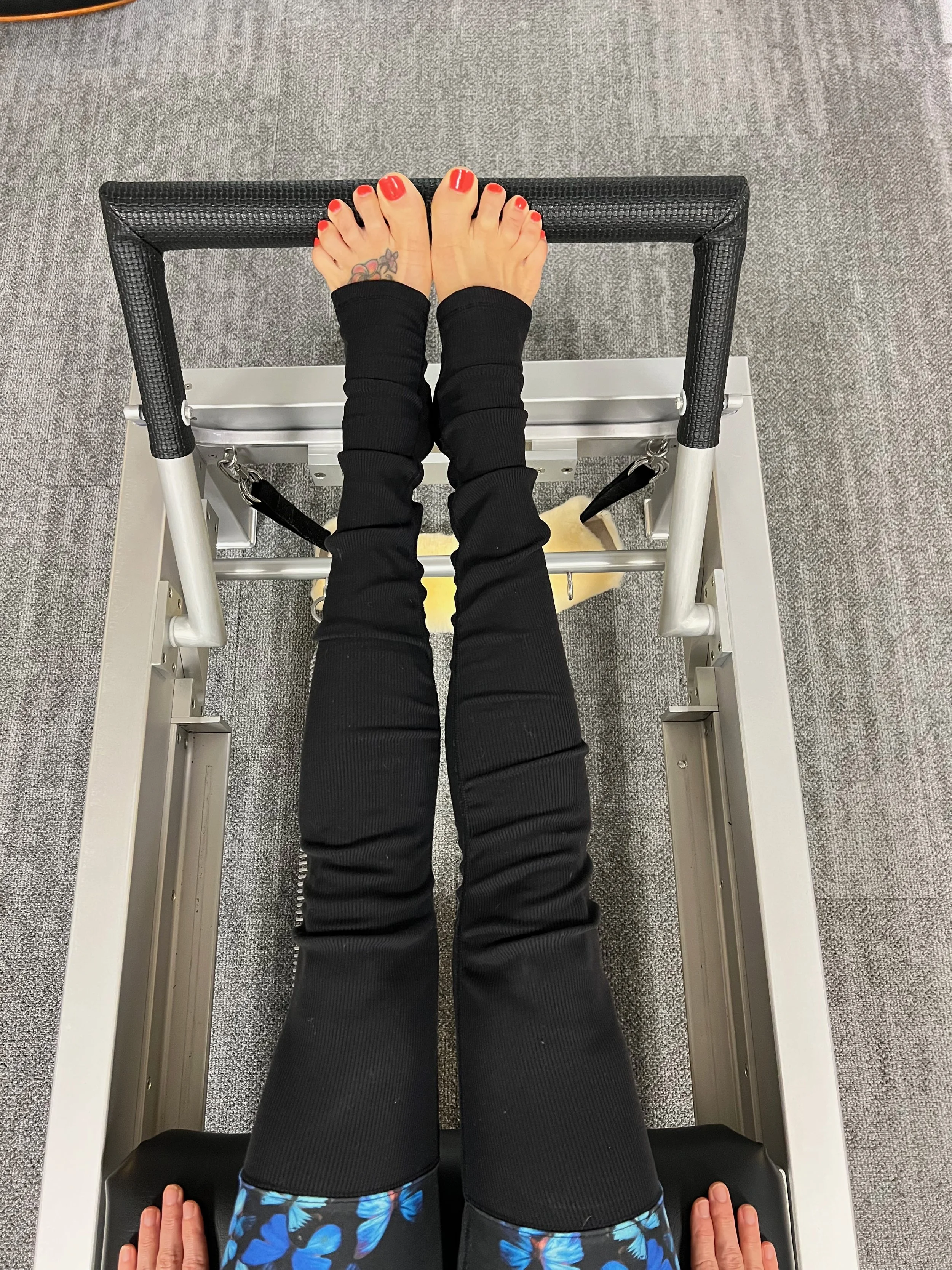 Close up view of foot placement on Pilates equipment for the purpose of instruction and online coaching in an online membership platform. Studio is in Chattanooga Tennessee