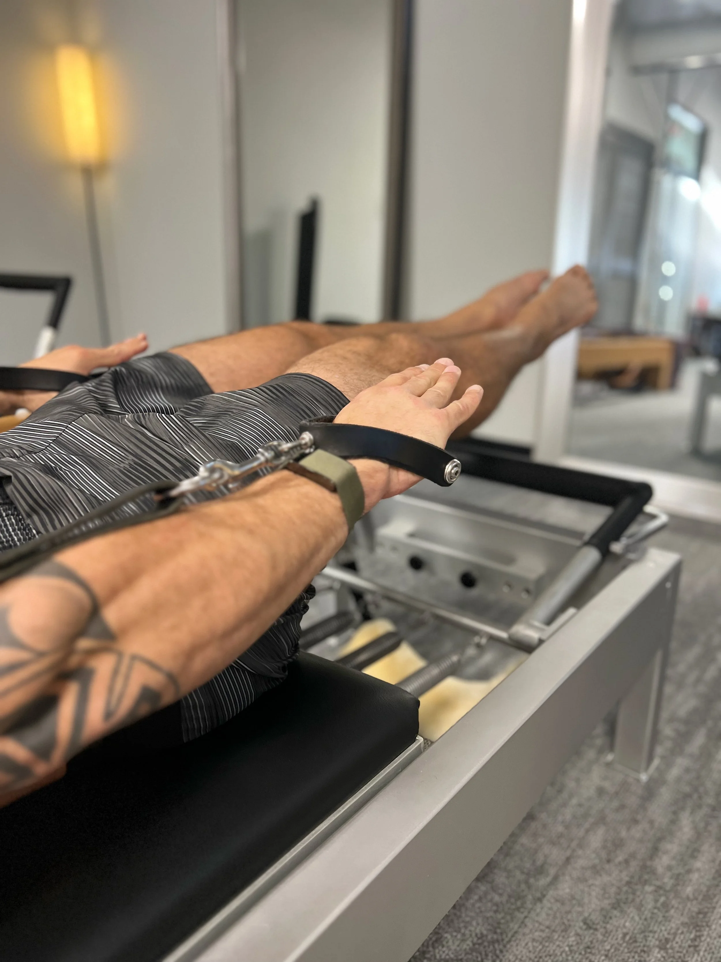 Close up image of Mike Kyser demonstrating advanced Pilates movement and body control for Online learning platform. Pilates and mobility membership platform