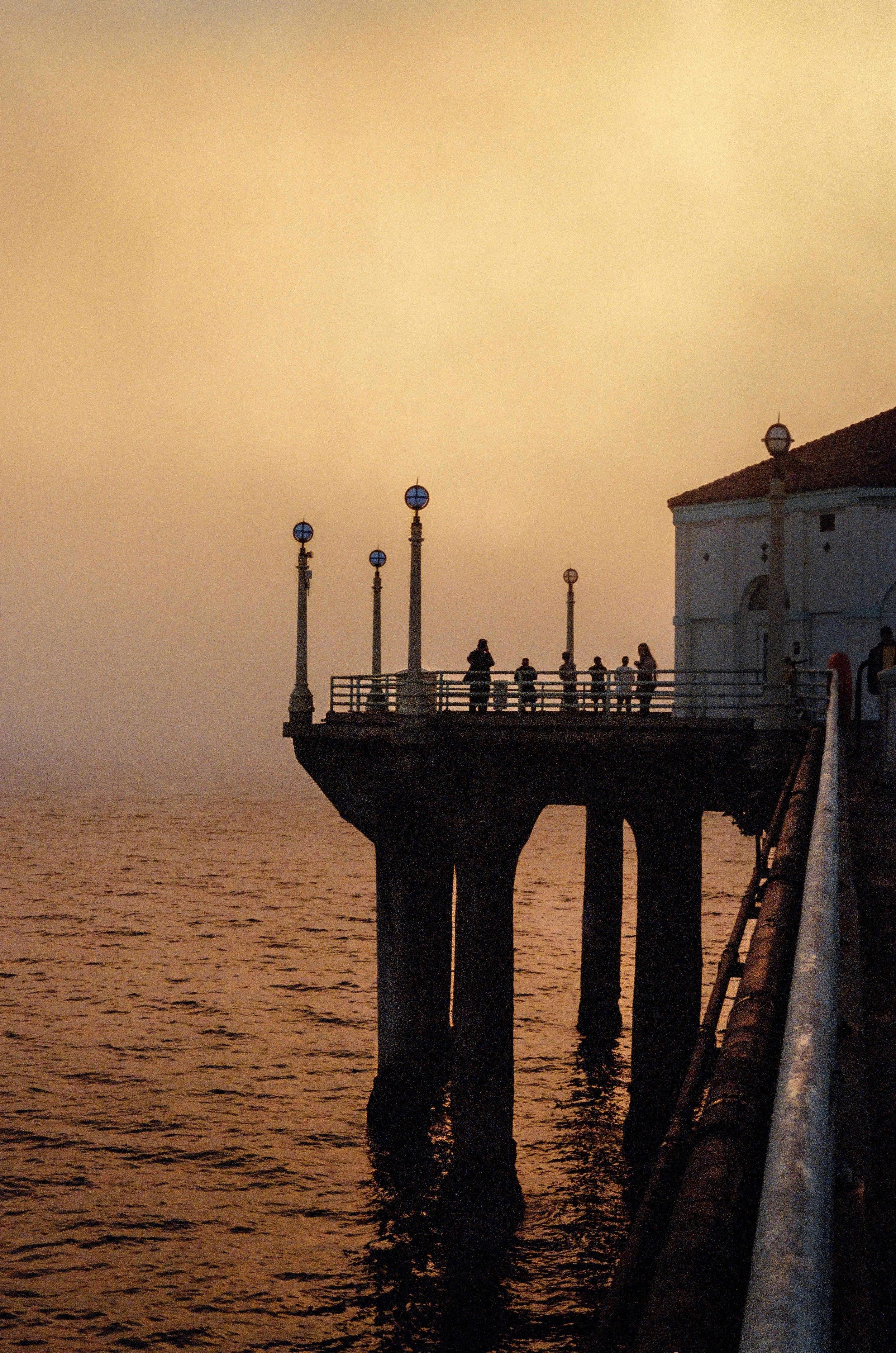 Manhattan Beach Pier as a fog cloud suddenly appeared, illuminated by the setting sun.
