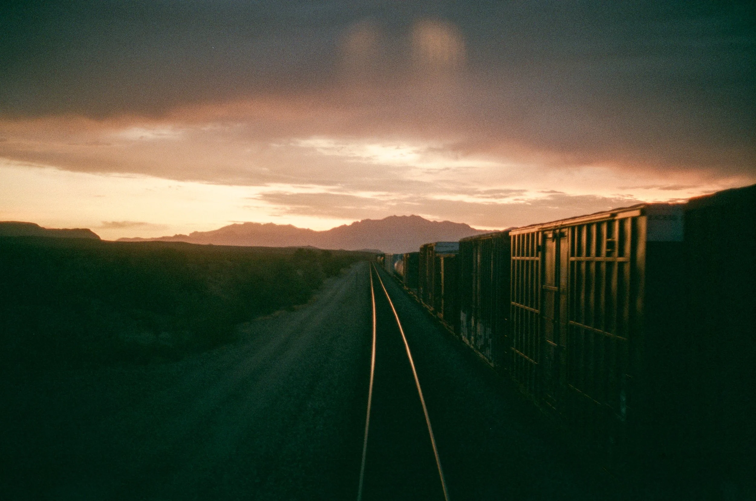 Sunrise from the caboose of a train, heading west across the Arizona desert.