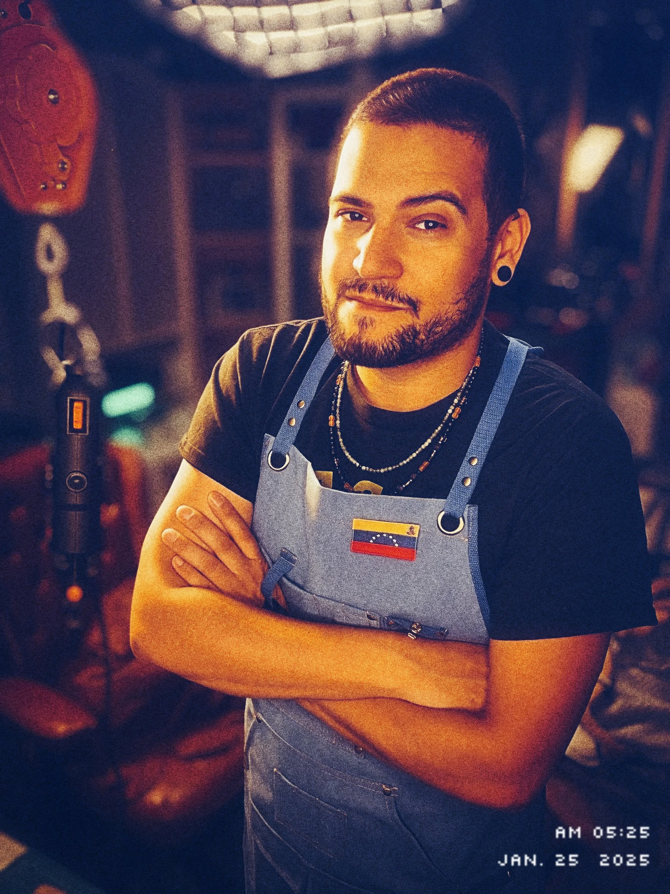 Latino man posing with a blue apron