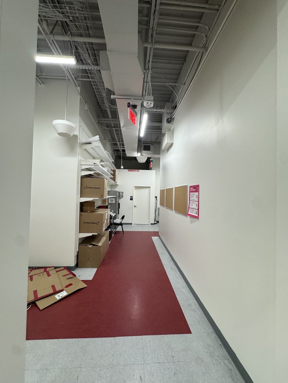 Commercial mall hallway with exposed ceiling and wall painting completed by Element Coatings.