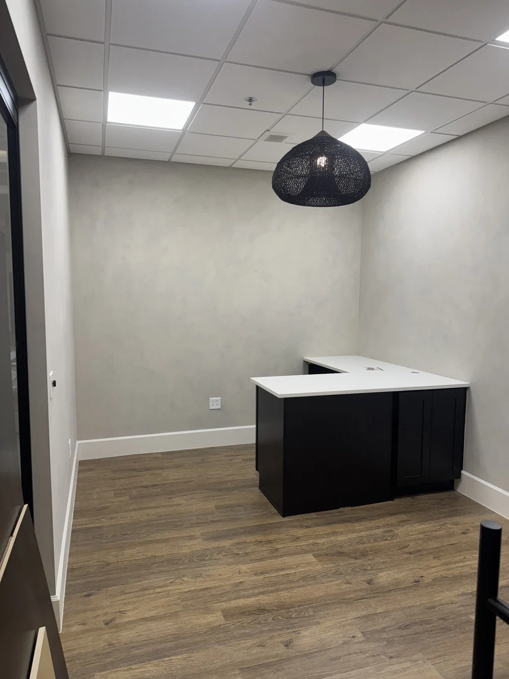 Custom commercial limewash finish completed in a retail store by Element Coatings.