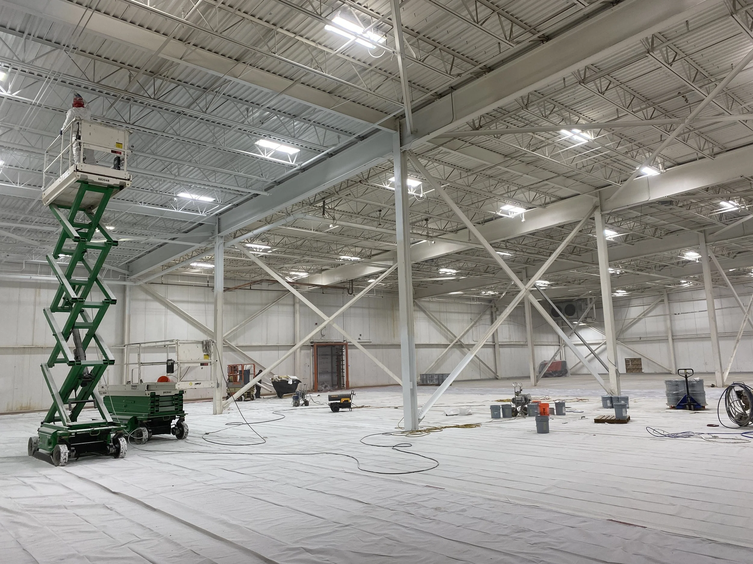 Professional dryfall ceiling painting, Bond-Plex wall coatings, and structural steel beam painting completed in a commercial freezer warehouse in Salt Lake City, Utah.