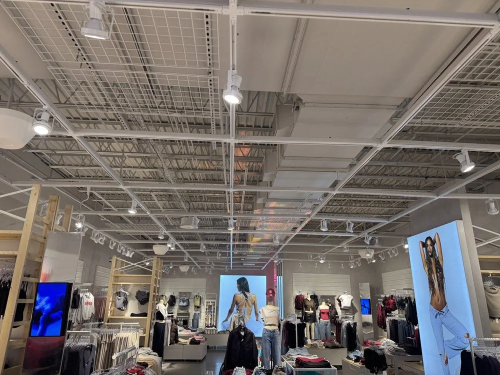 Commercial retail store featuring exposed ceiling painting and custom Marrakech decorative plaster walls completed by Element Coatings.