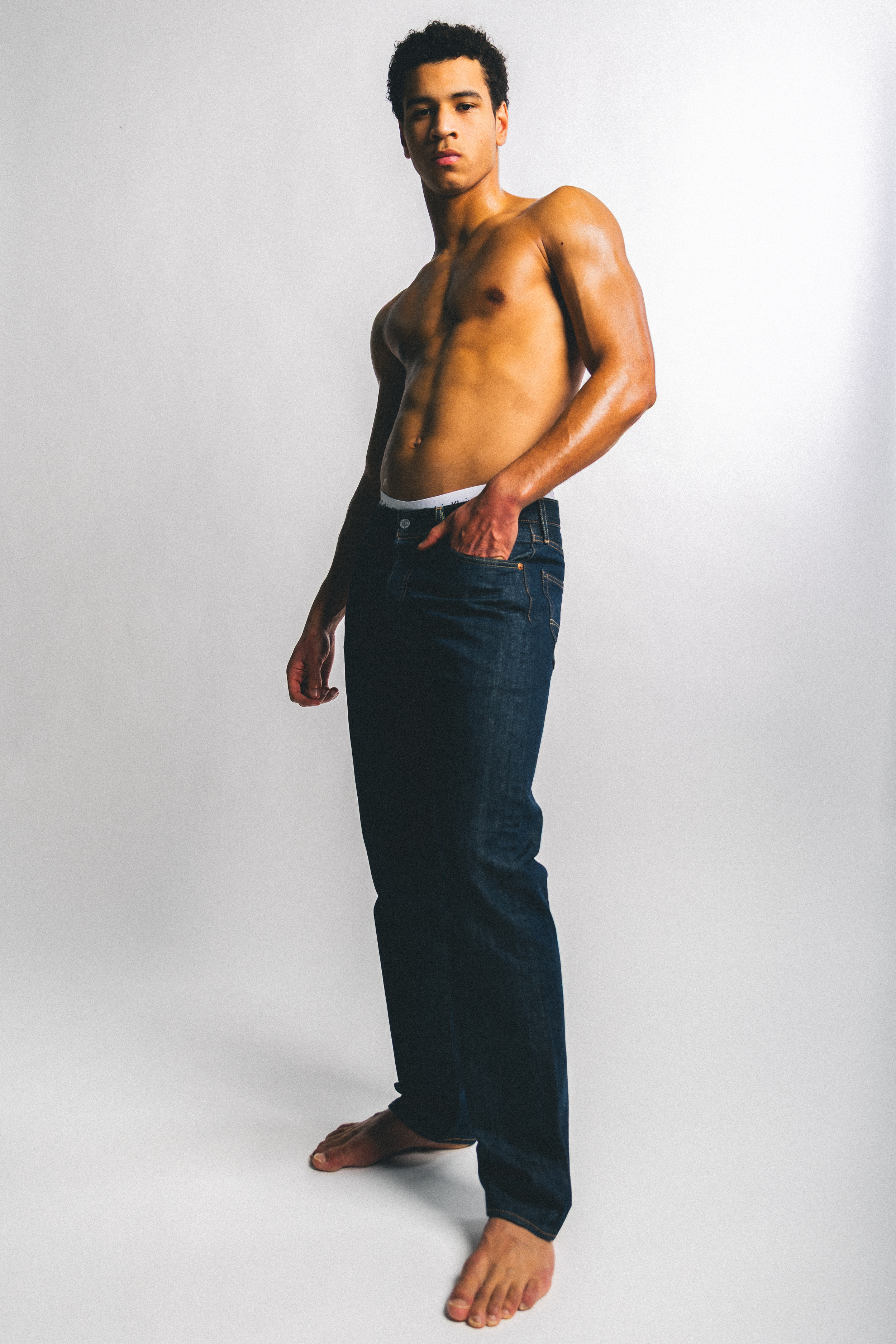 Henkilökuva nuori mies ilman paitaa studiossa