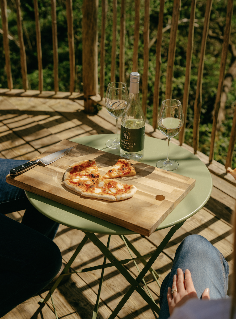 Pizza and Brook House wine served on a treehouse deck at Brook House Woods