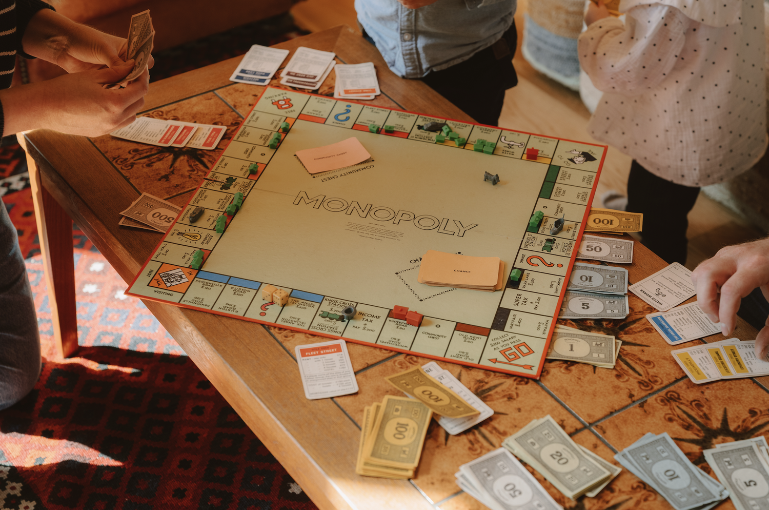 Family and friends playing a board game together inside Journeyman Treehouse