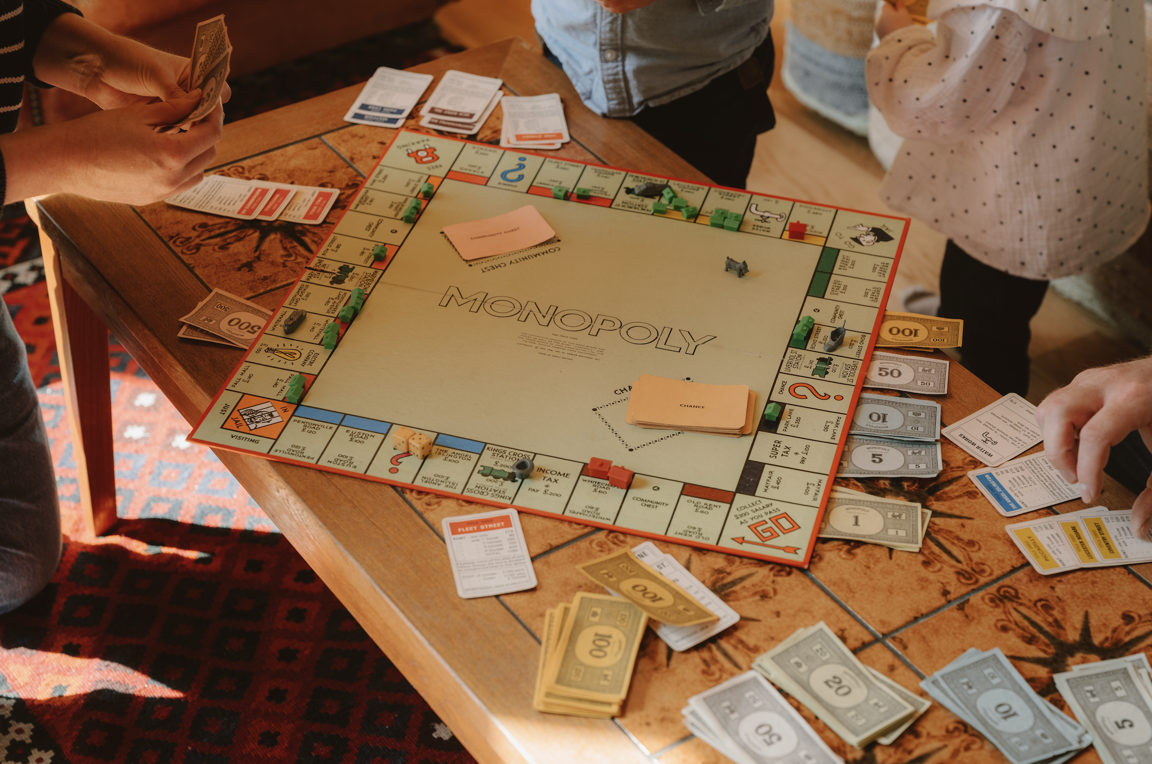 Family and friends playing a board game together inside Journeyman Treehouse