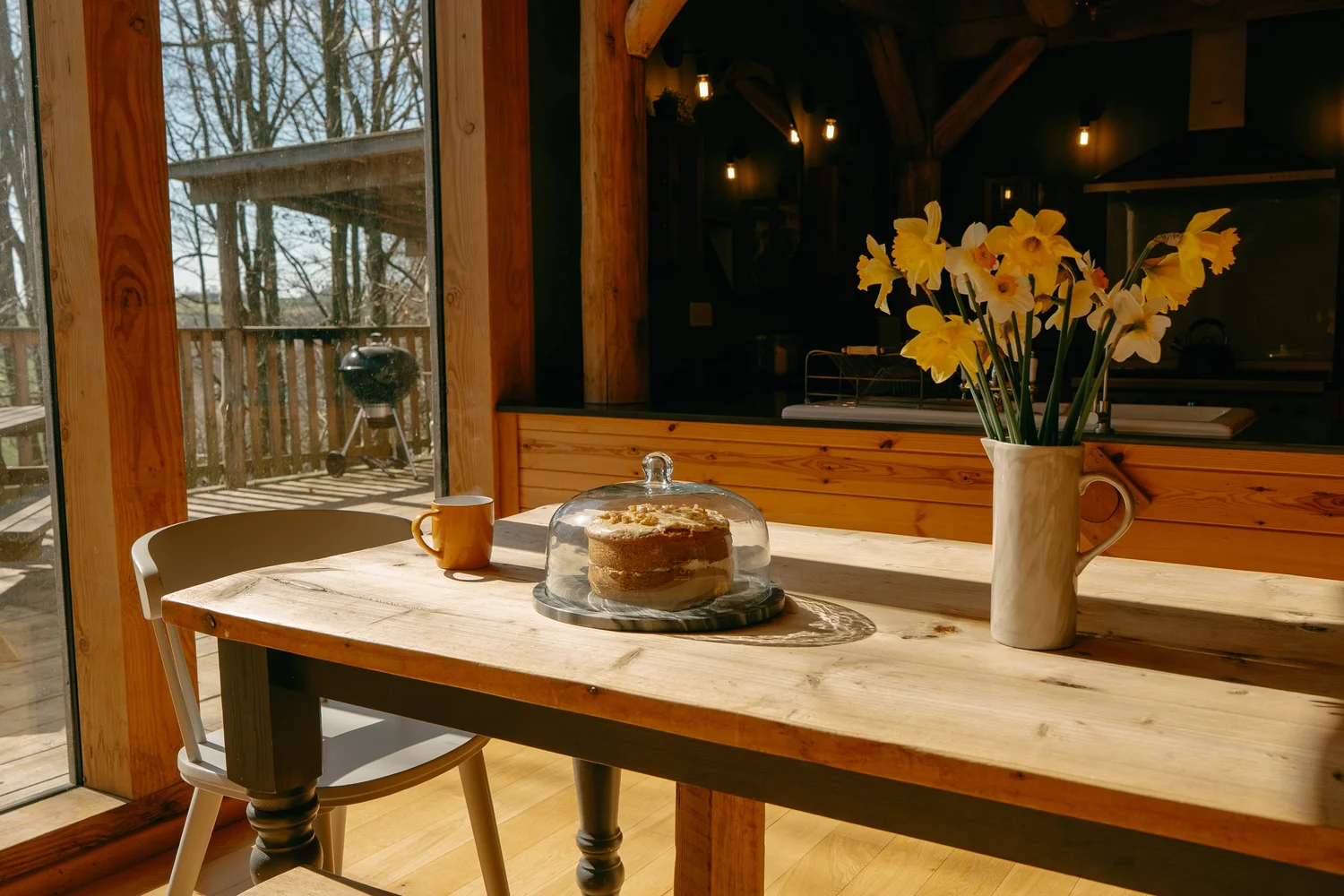 Pancakes and daffodils on the sunlit kitchen table