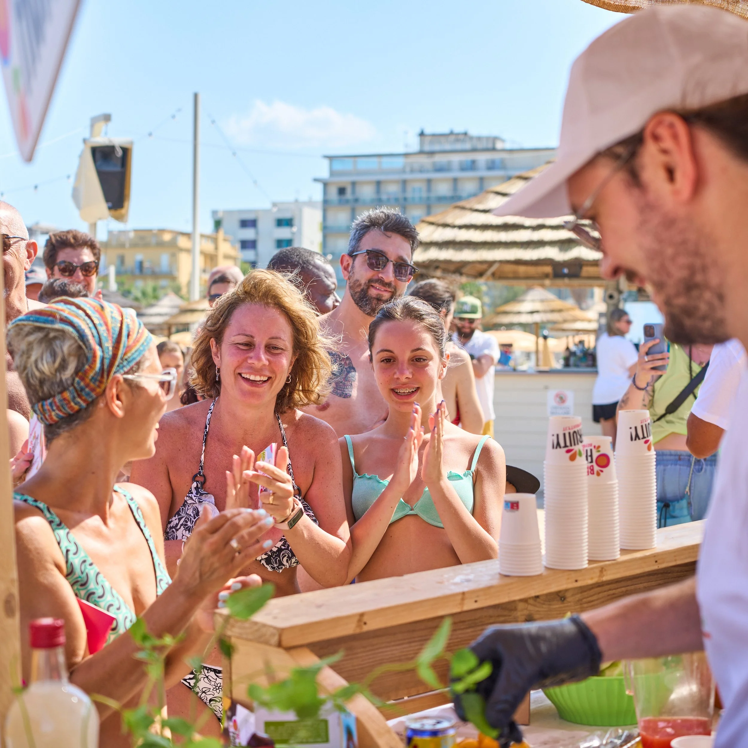 Families on the beach tasting fruit during the Be Fruity event in Rimini