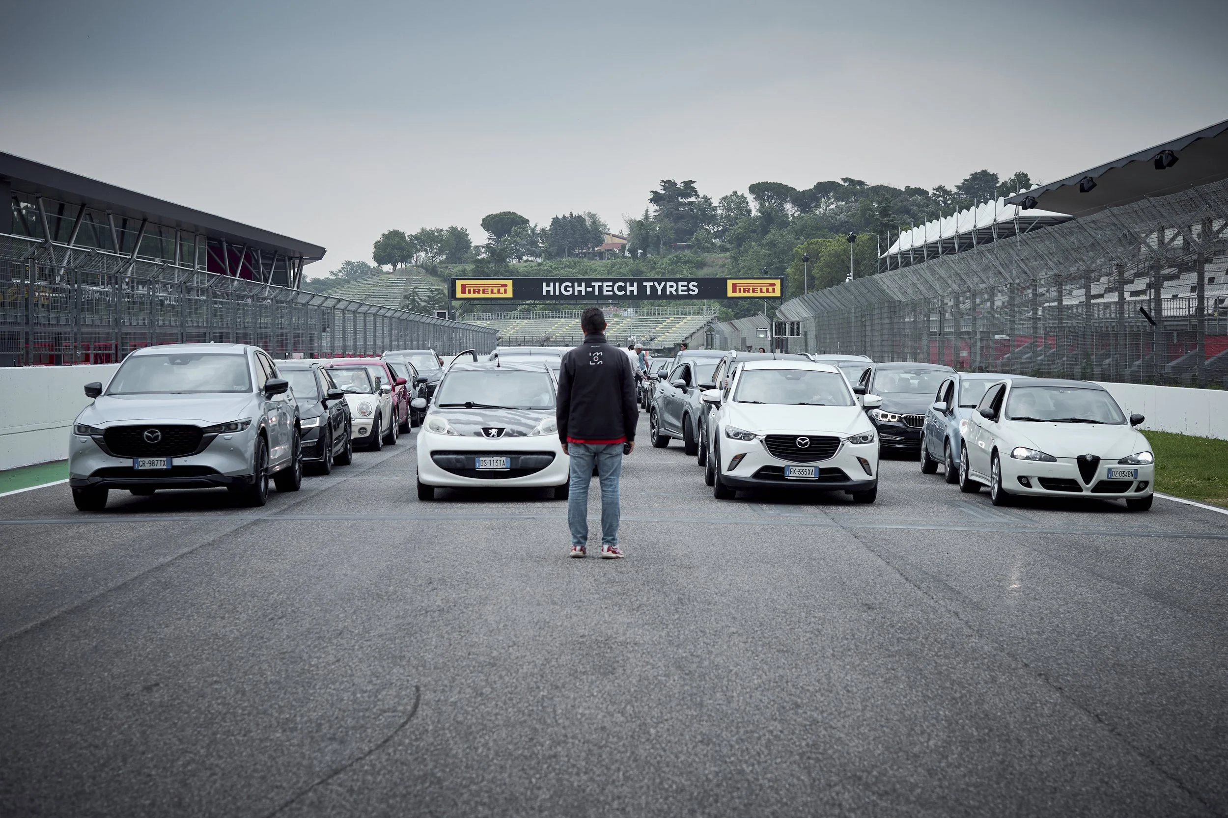 Participants driving their own cars on the Imola circuit during Cyberama 2025