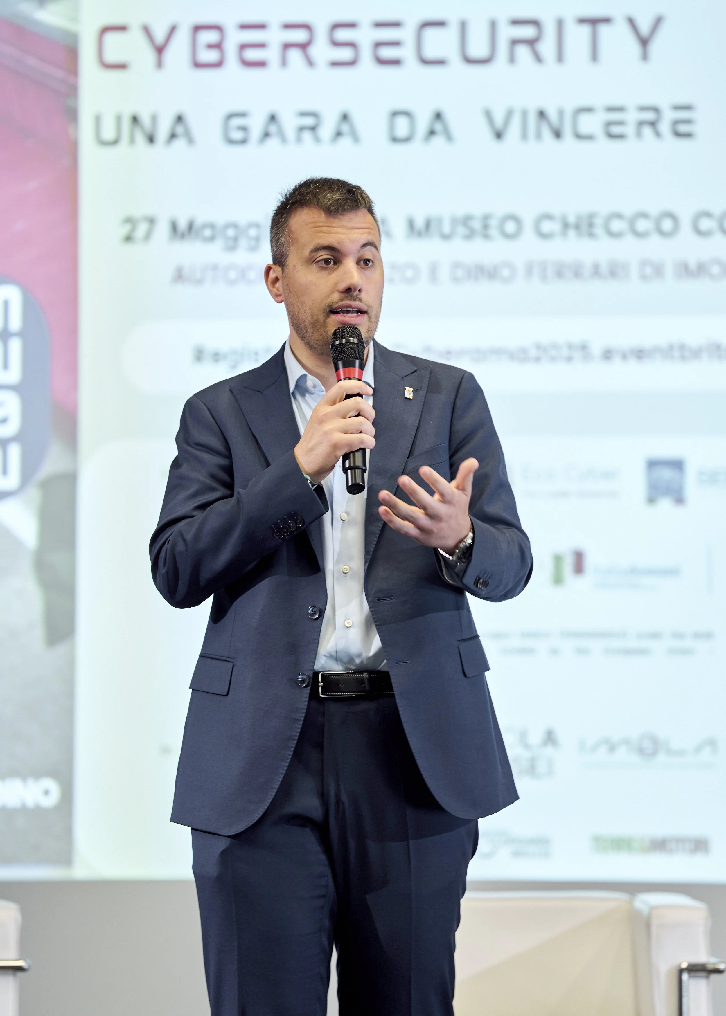 Speaker on stage at Cyberama 2025 cybersecurity conference in Imola