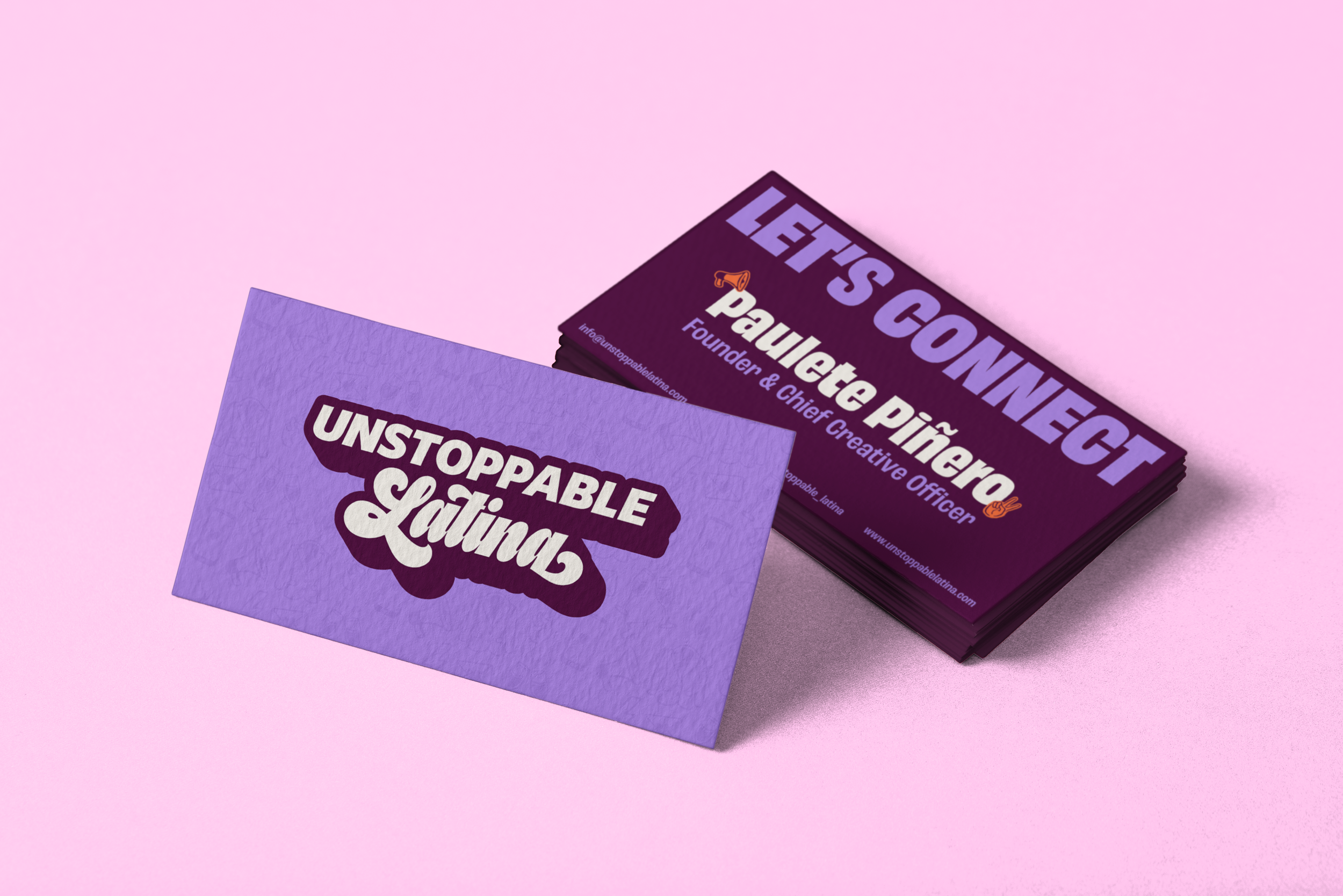 Business card in purple at an angle showing Unstoppable Latina logo, stack of cards in the behind showing the founder's information for contact, displayed over a pink background.