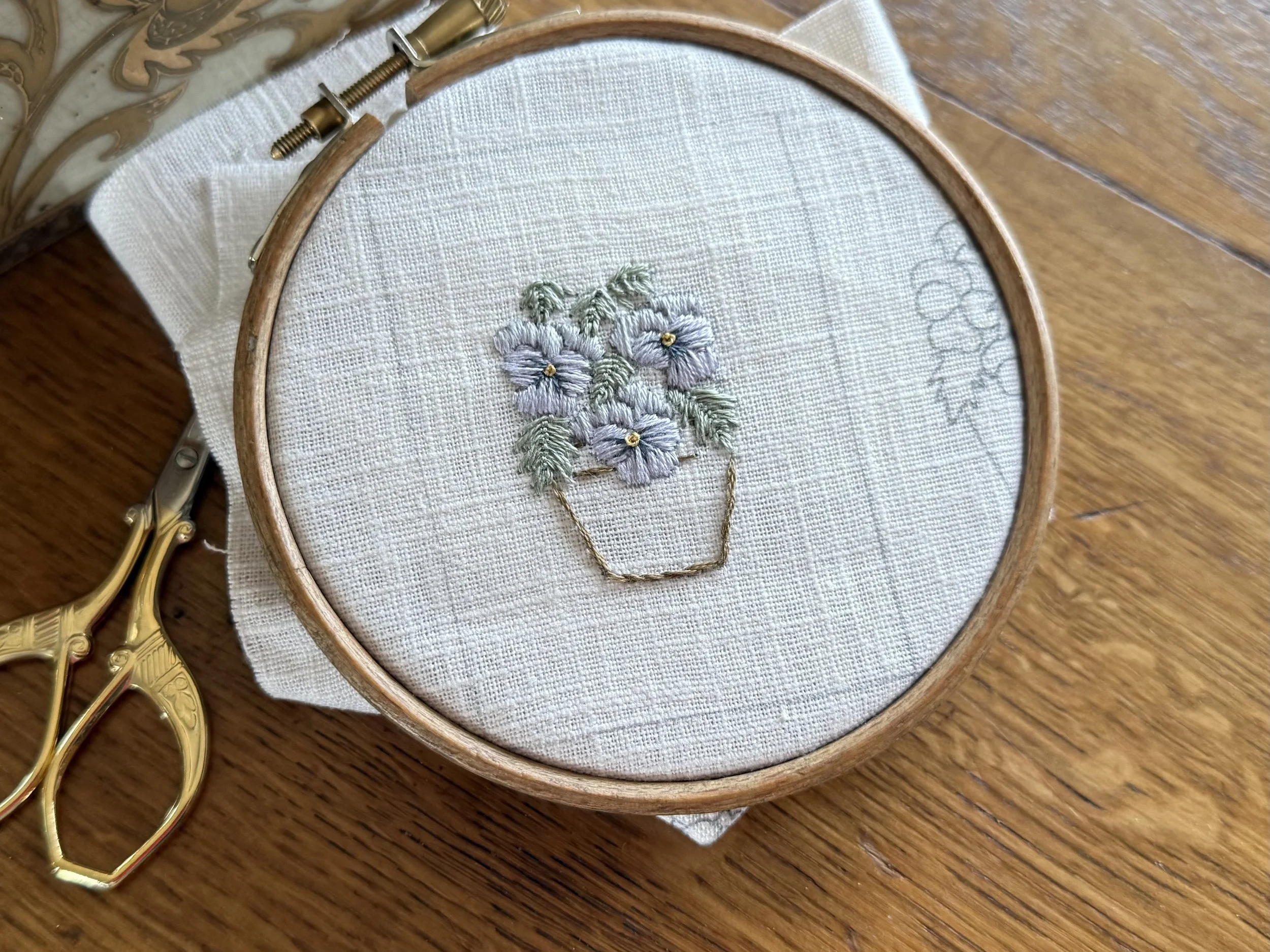 Hand embroidered pansies in a pot