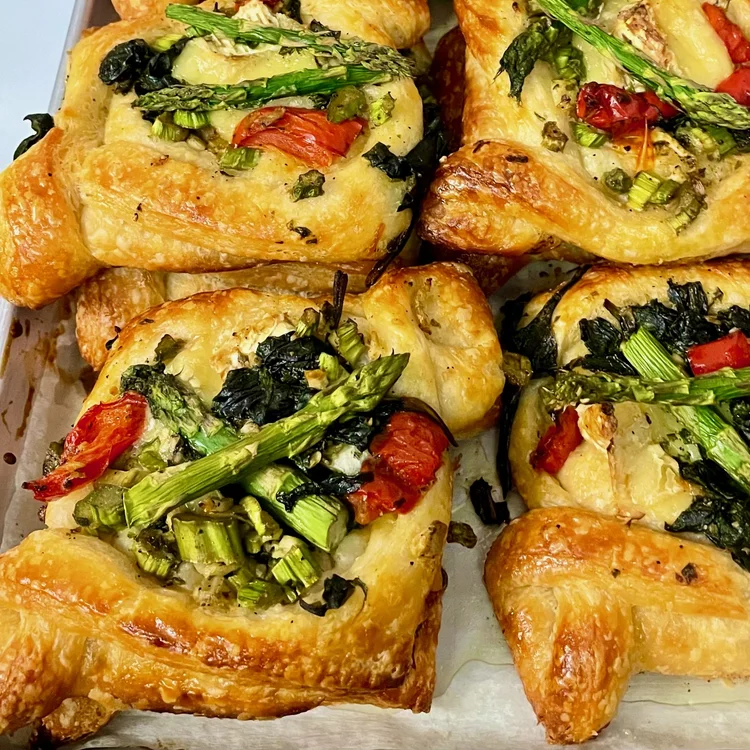 Golden croissants topped with colorful seasonal vegetables from The Baker and the Cakemaker