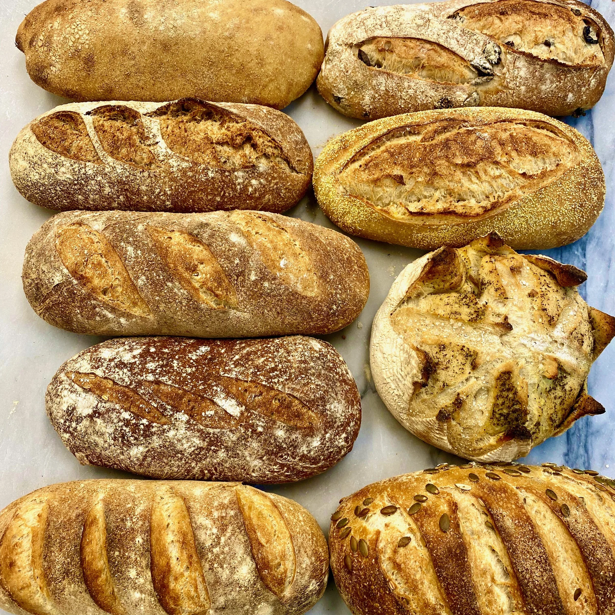 Assorted artisan sourdough loaves from The Baker & The Cakemaker in Auburn, California