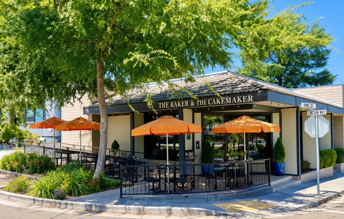 The Baker and the Cakemaker café in Auburn, with orange umbrellas and outdoor patio seating