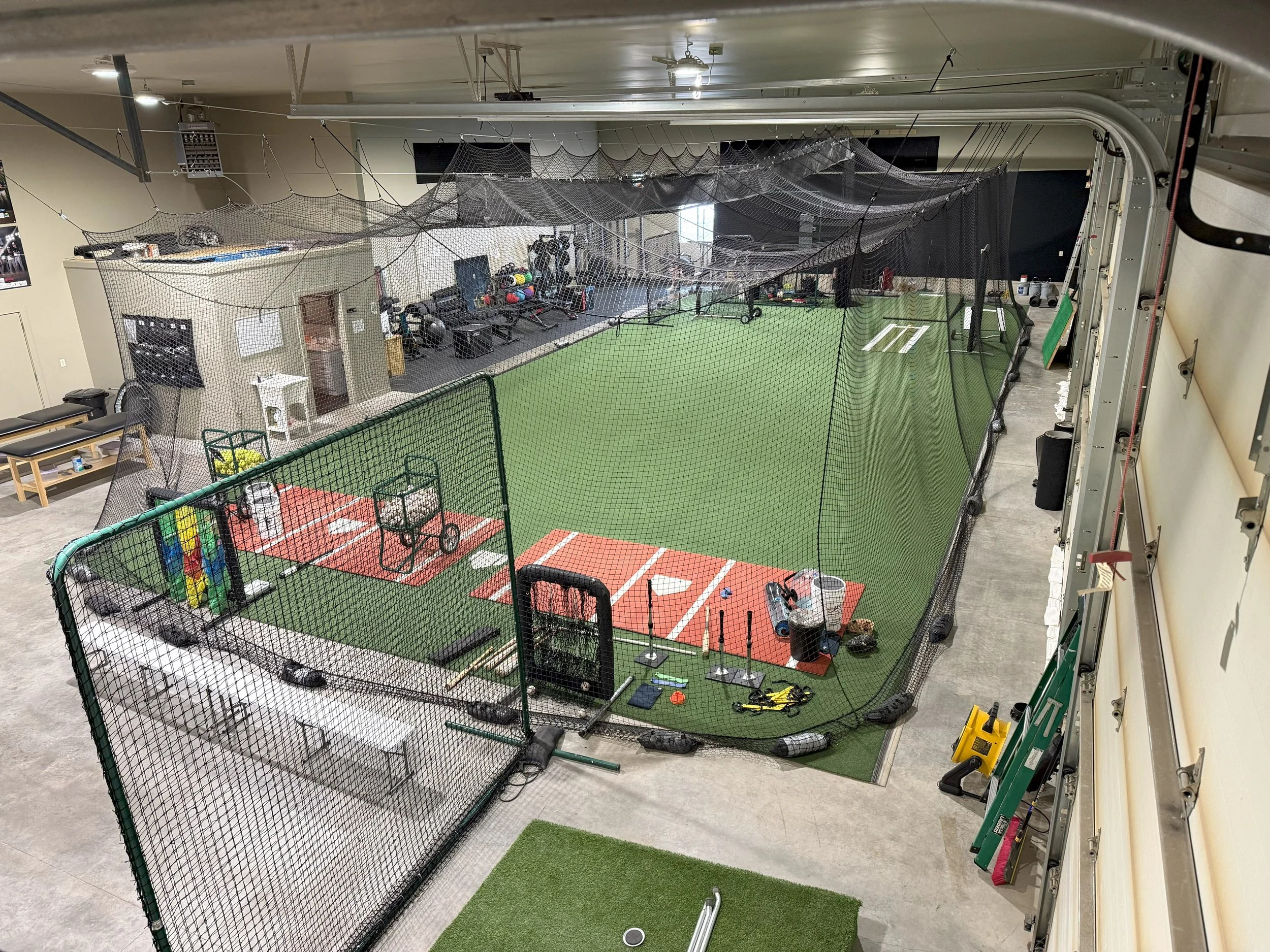 Indoor baseball and softball facility with two tunnels, pitching machines, weight room, arm care area, medicine ball area, hitting and pitching areas.