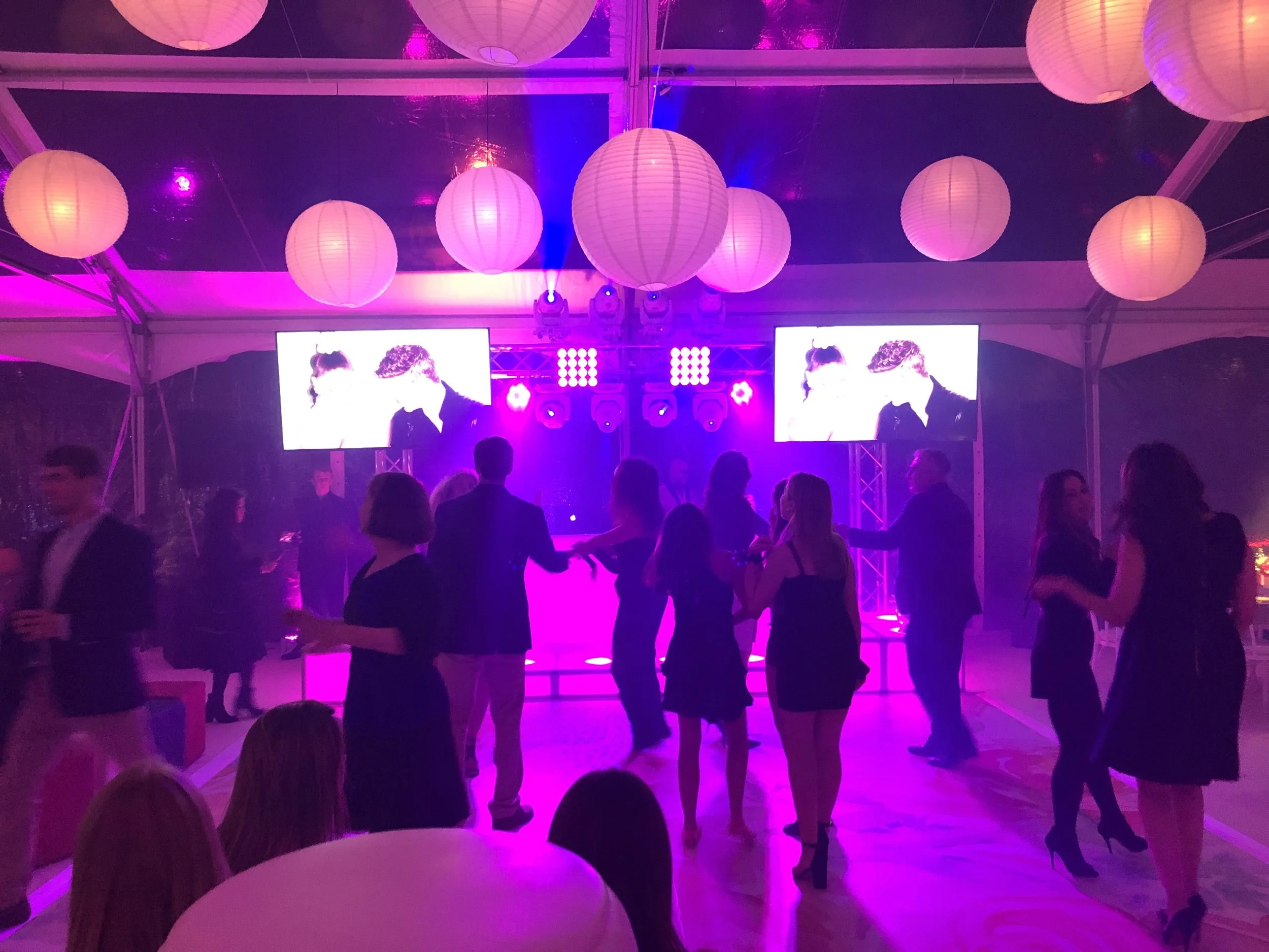 Teen dance floor with twin AV screens and stage lighting in Connecticut event tent