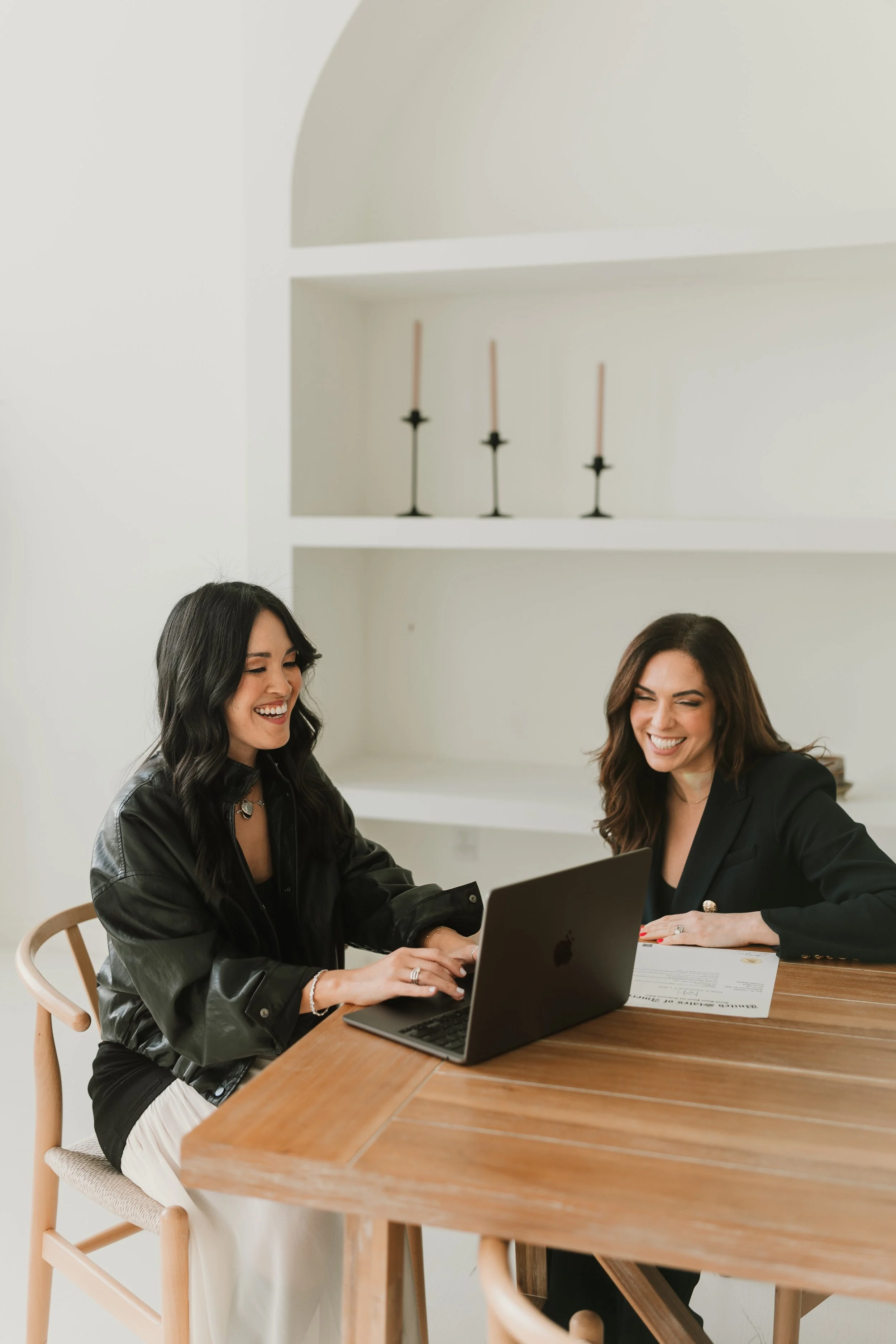 Mika Mooney types on her laptop while supporting a female founder with trademark registration