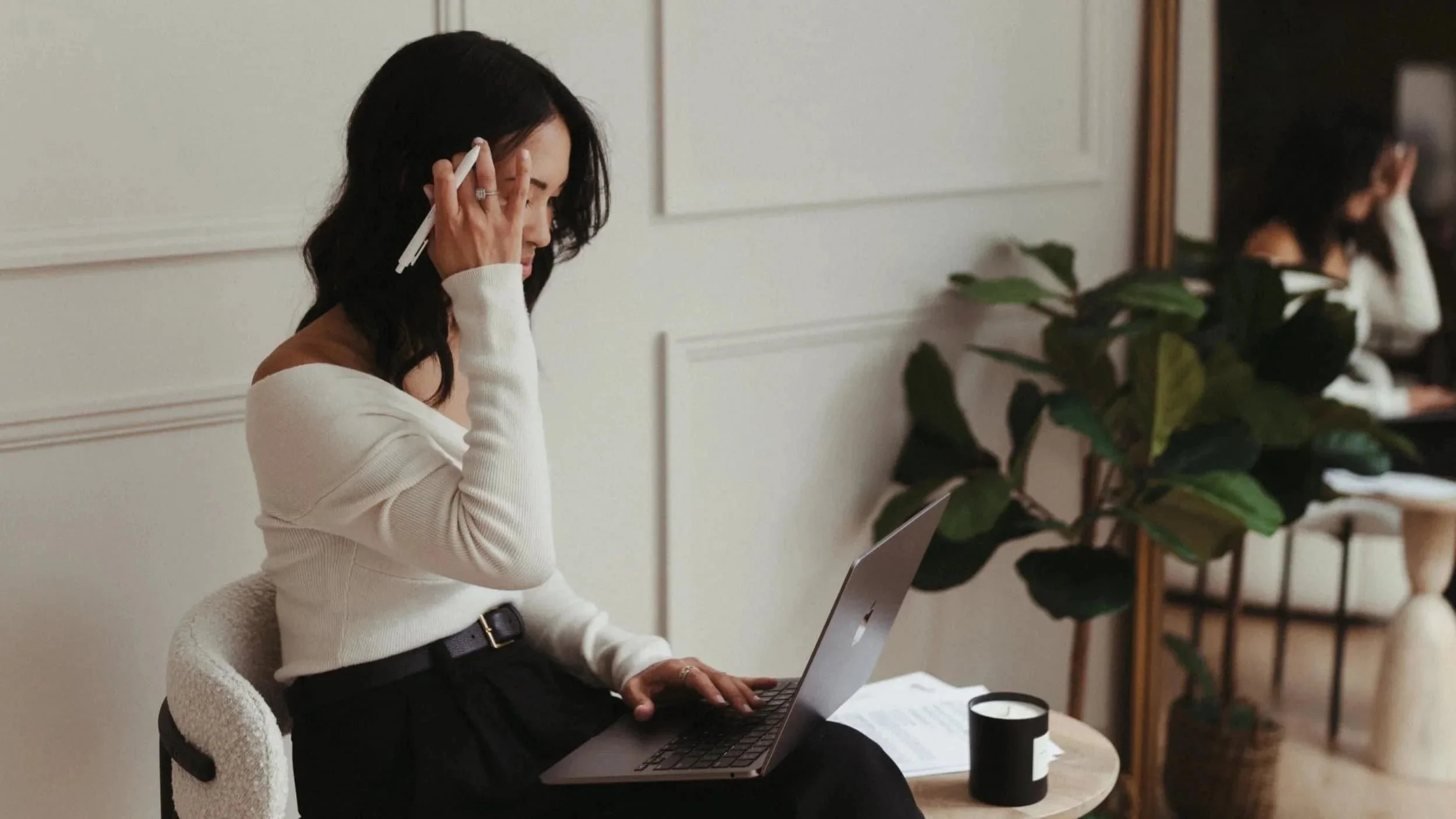 Trademark attorney Mika Mooney working on her laptop to share a list of trademark classes with a client