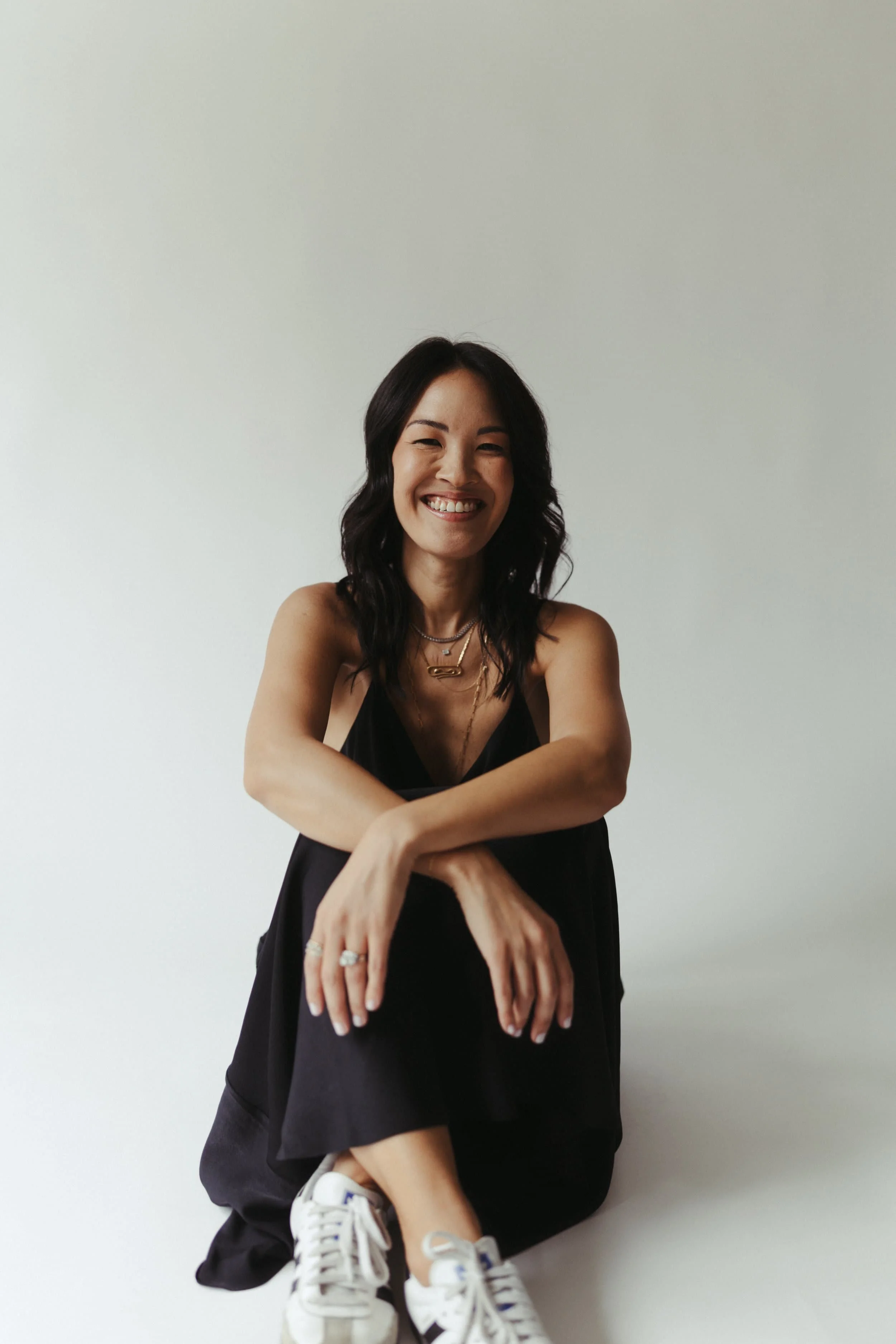 Mika Mooney, trademark, business, and employment attorney, smiling in a modern editorial portrait.